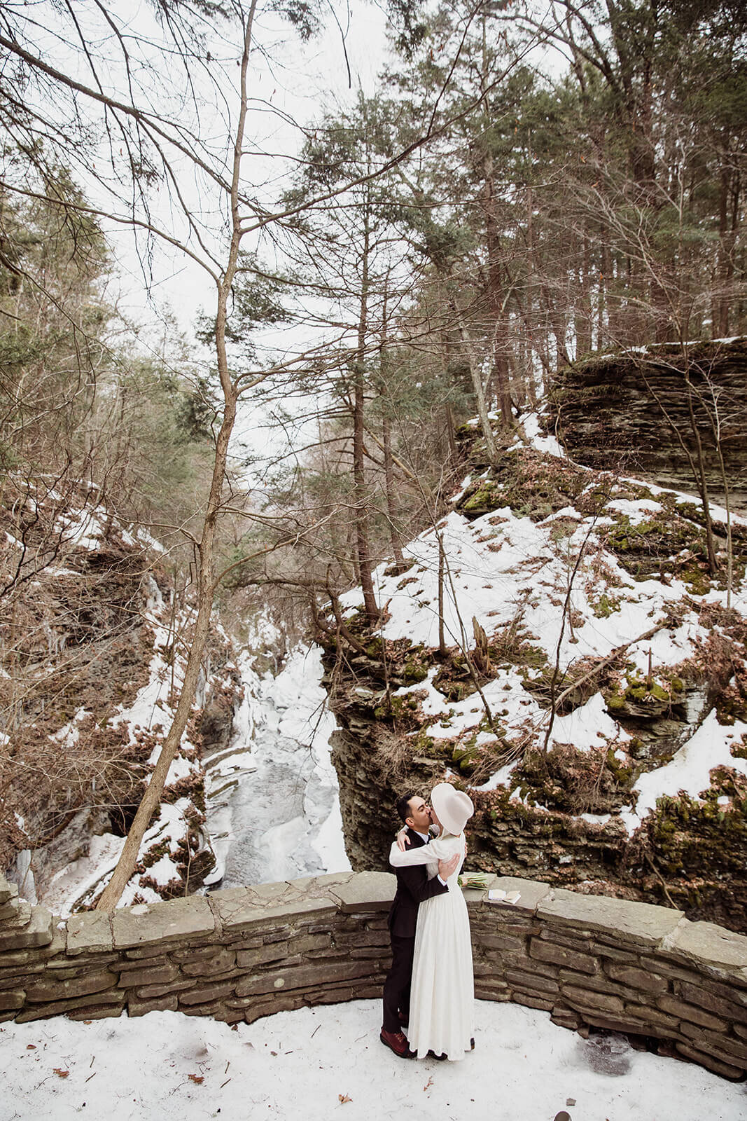  Stylish NYC couple elope late winter in the Finger Lakes region of Upstate NY. Couple exchanges vows and rings during ceremony. 