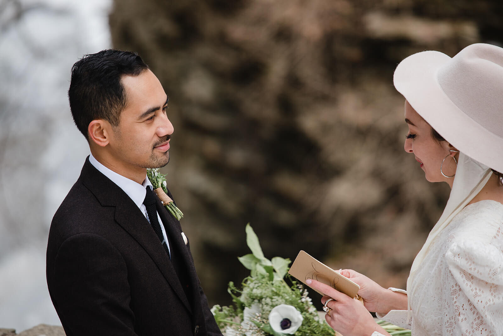  Stylish NYC couple elope late winter in the Finger Lakes region of Upstate NY. Couple exchanges vows and rings during ceremony. 