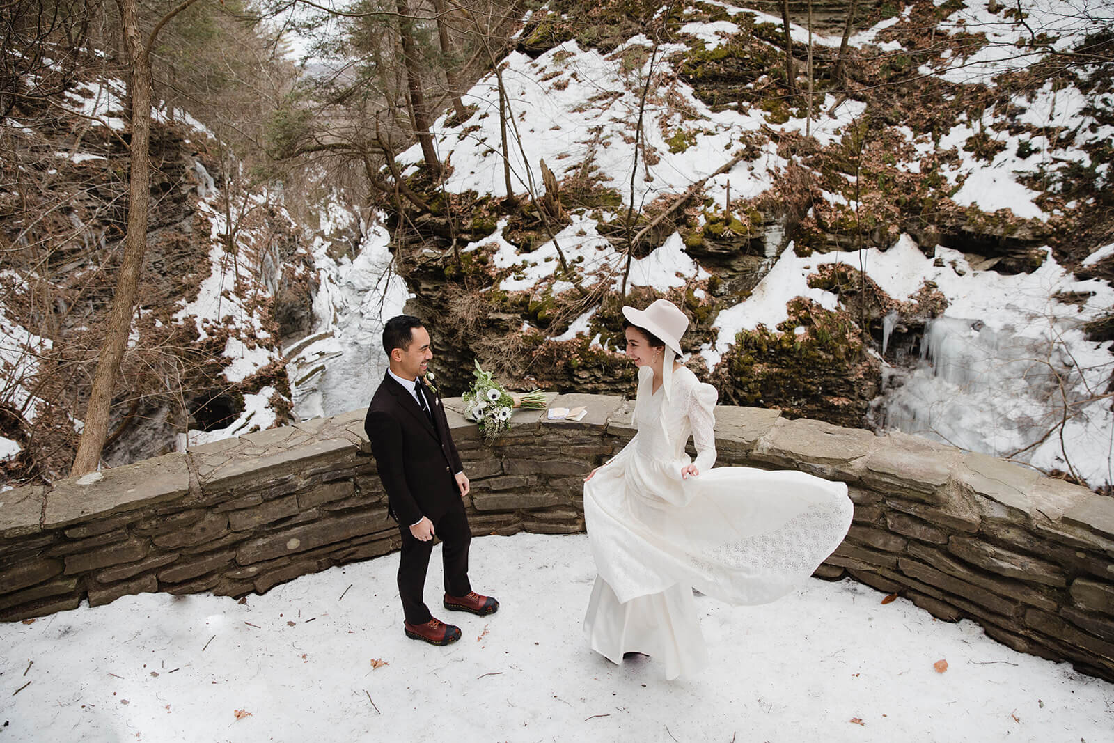  Stylish NYC couple elope late winter in the Finger Lakes region of Upstate NY. Couple exchanges vows and rings during ceremony. 