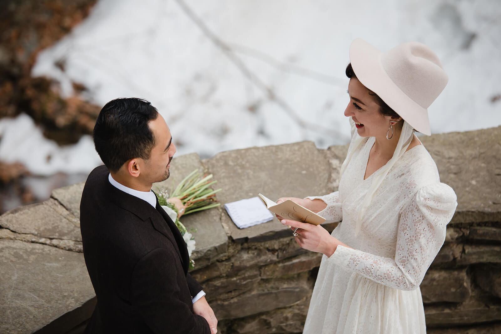  Stylish NYC couple elope late winter in the Finger Lakes region of Upstate NY. Couple exchanges vows and rings during ceremony. 