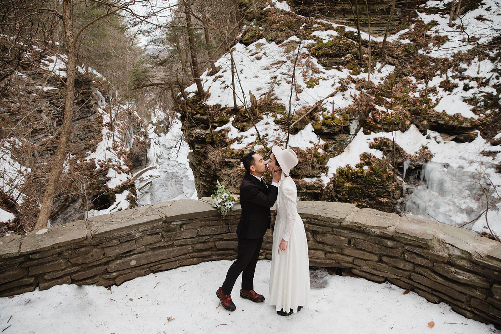  Stylish NYC couple elope late winter in the Finger Lakes region of Upstate NY. Couple exchanges vows and rings during ceremony. 