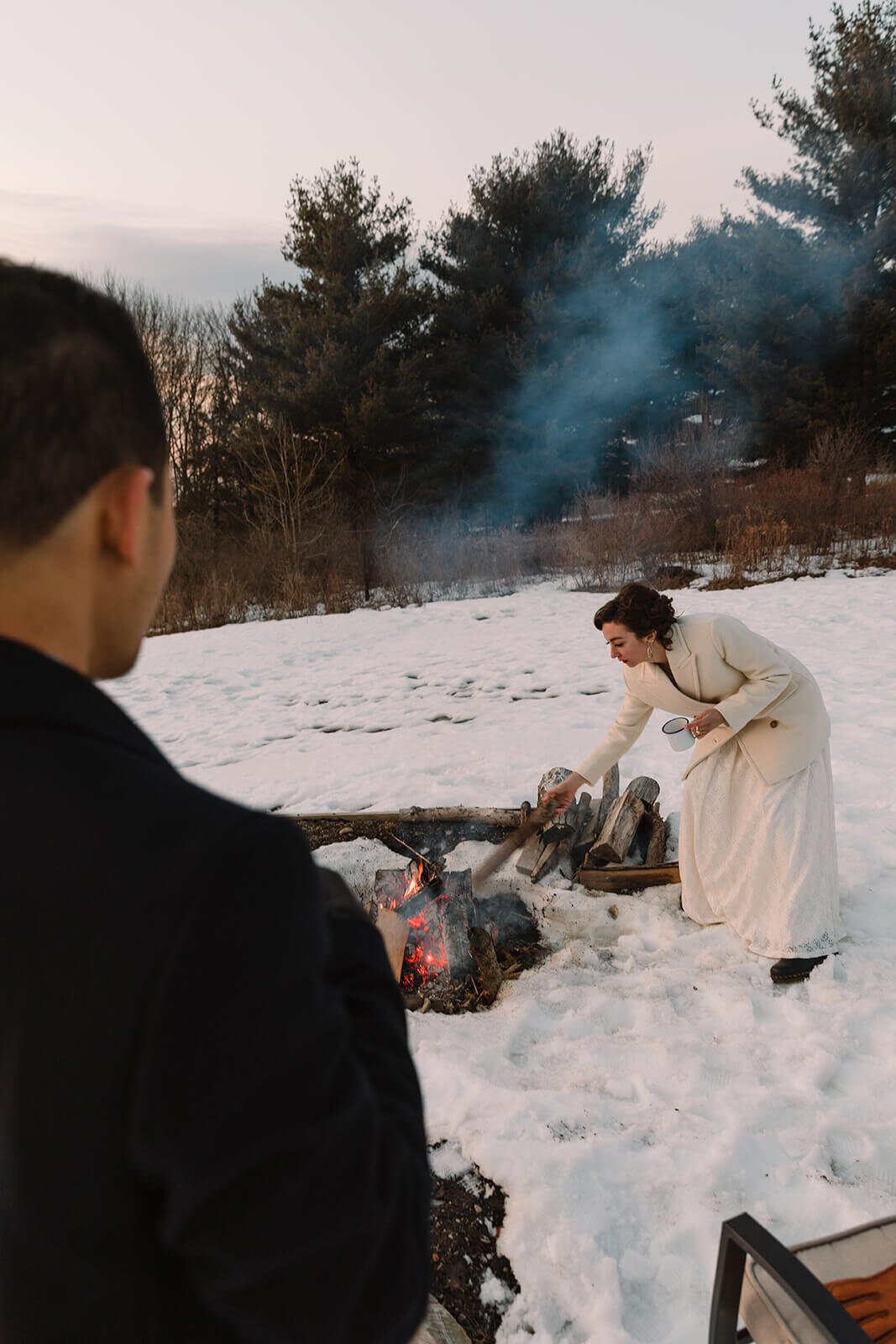  Stylish NYC couple elope late winter in the Finger Lakes region of Upstate NY.  Drinks by the campfire during sunset 