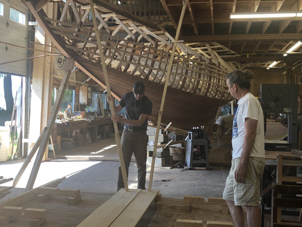  Boats are built right-side up on the floor rather than on a strongback. They are braced using props that extend from the floor or ceiling. 