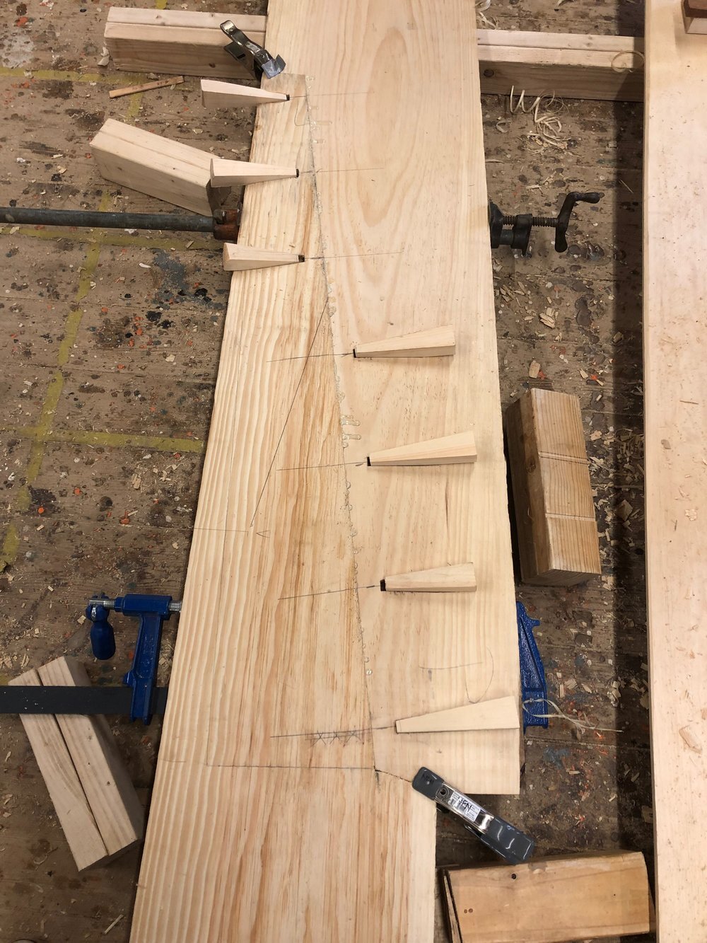  You can see the scarf joint cut in one of the side planks to join two pieces together. The side planks are edge nailed in the same way the bottom planks are. 