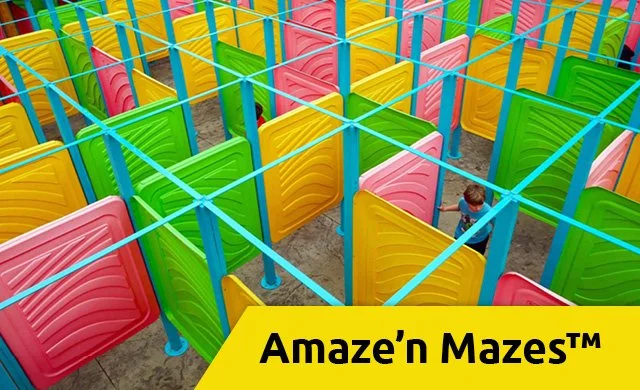 Guests navigating the Amaze’n Mazes attraction at Allegan Event, featuring winding paths and colorful maze walls in a fun outdoor setting.