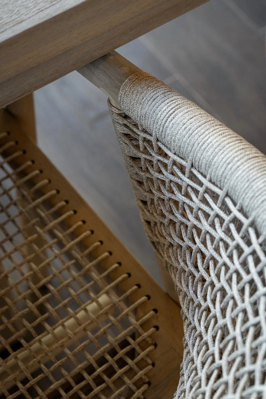 Close-up of a woven rope outdoor chair with a wooden frame, showing the weave in detail — interior design by Sarah Nicollier Interiors