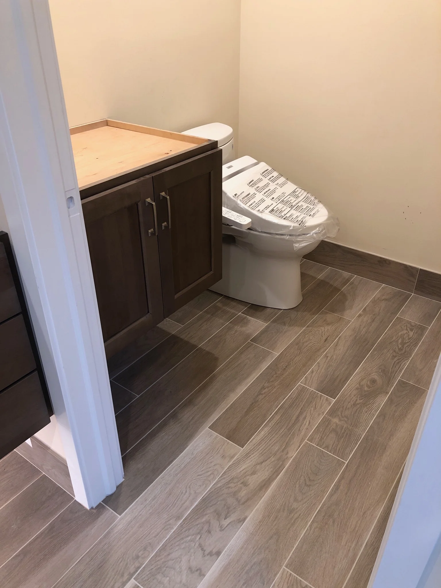 Toilet room newly grouted and waiting for Cambria quartz installation.