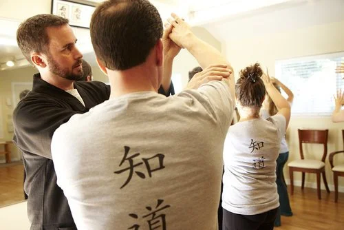 Dr. Sweeney providing hands on correction in medical qigong classes