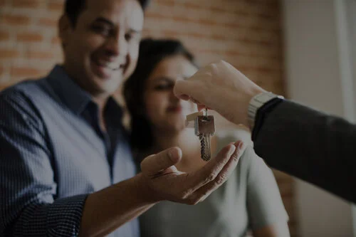 cheerful-couple-with-keys-their-new-home_53876-87076 copy.jpg