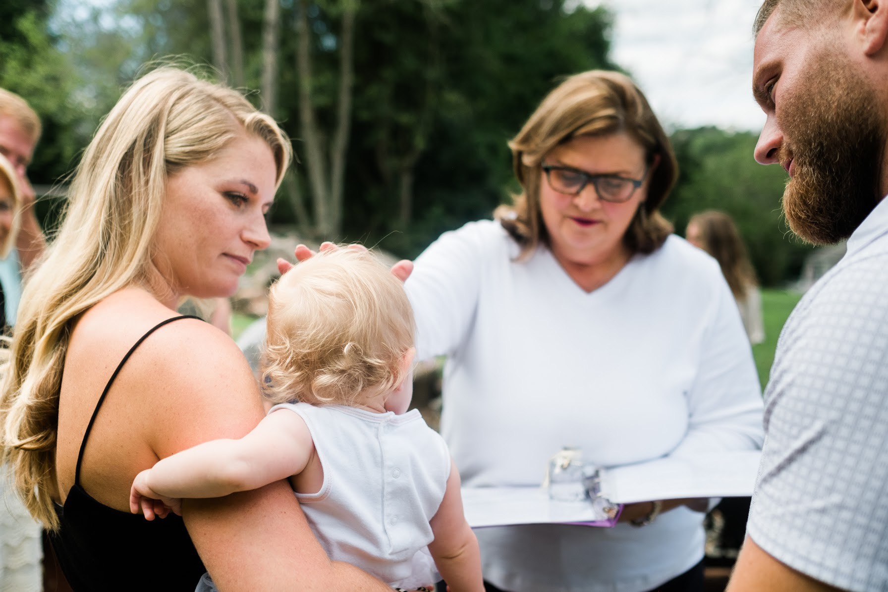 Linda Daring, of Daring Celebrations & Ceremonies, blesses the baby in a beautiful ceremony that honored the parents unique style and personality.
