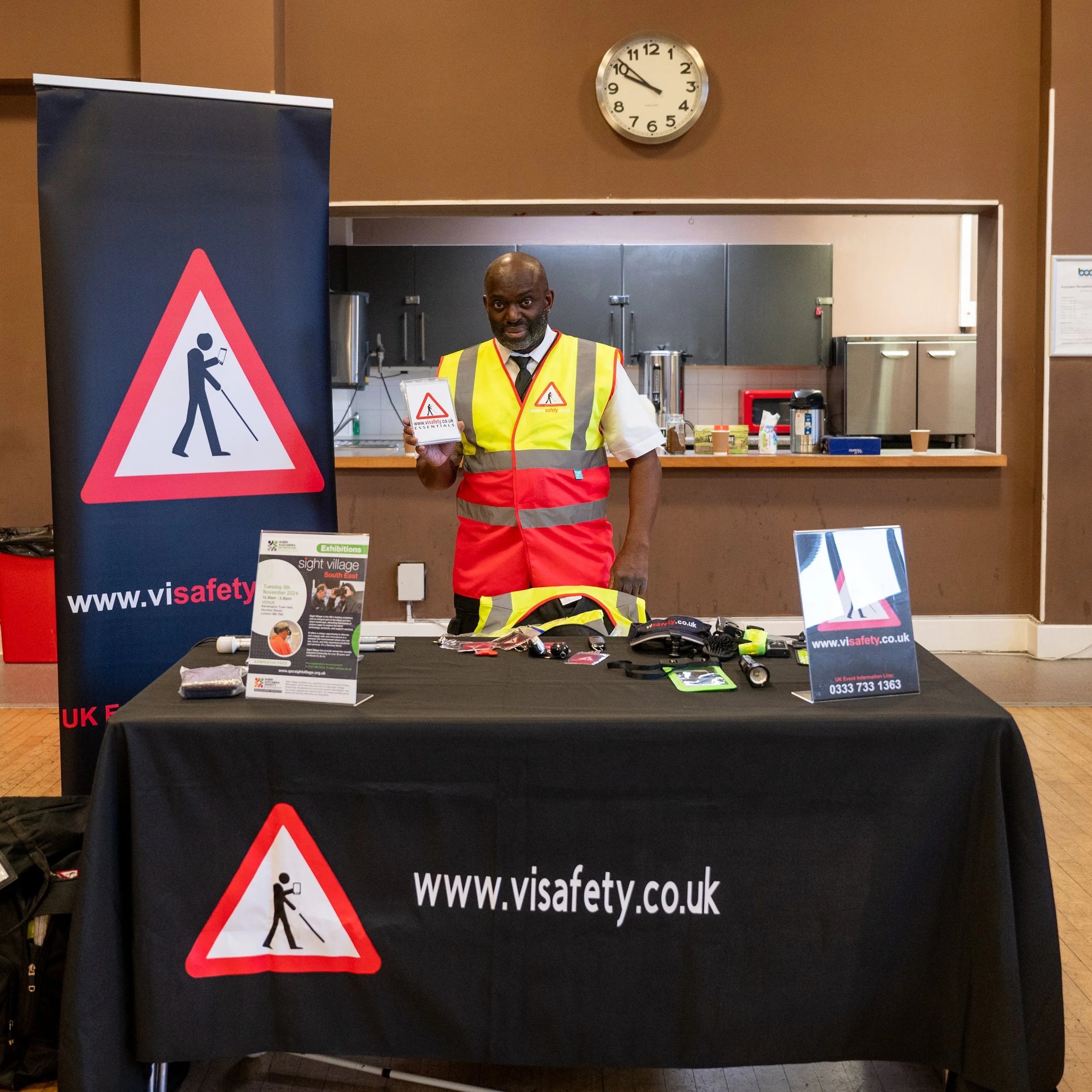  Andrew Palmer presenting in Barking. His products are in front of him on a large table that is branded  www.visafety.co.uk/  