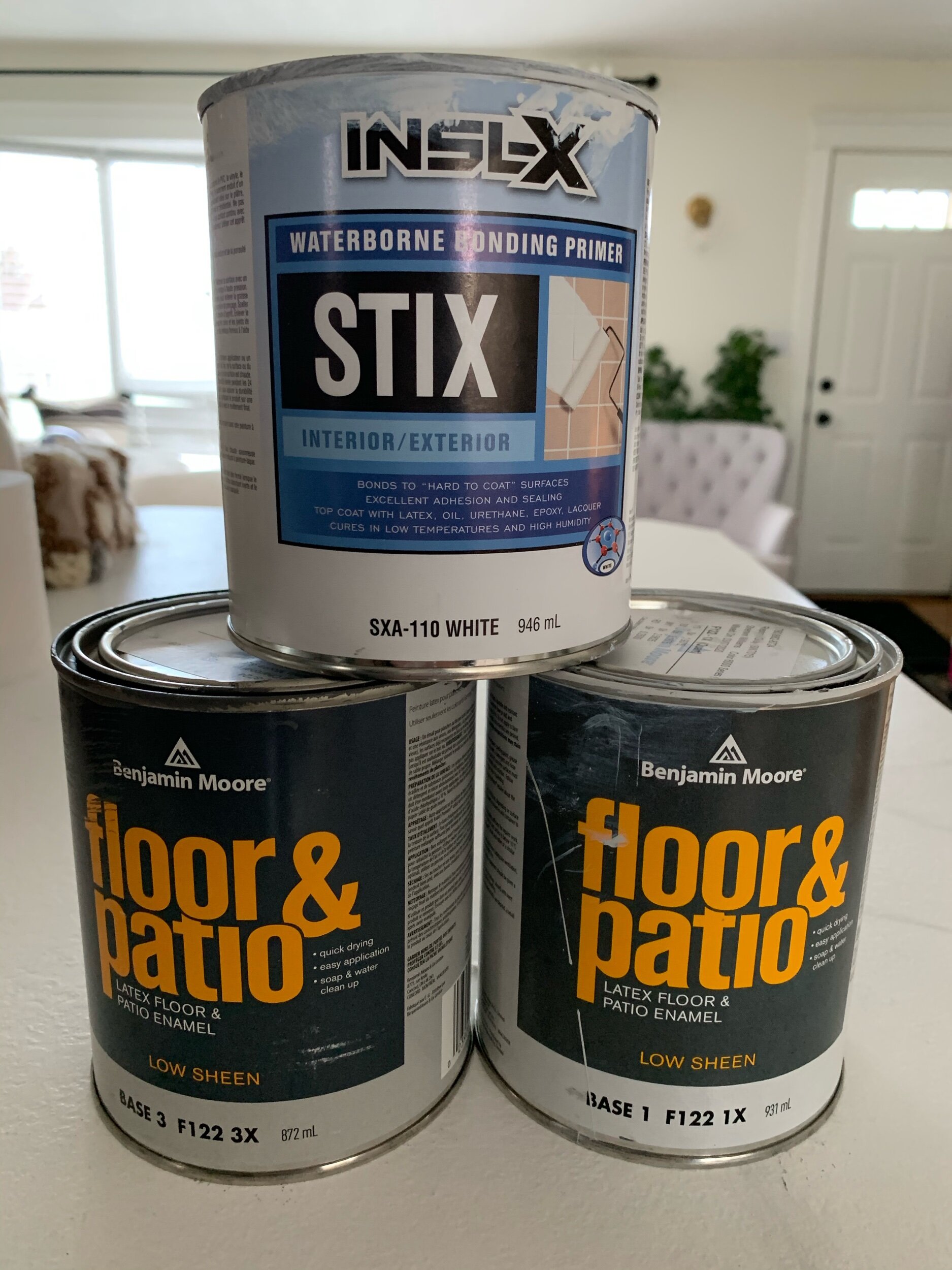 this is a photo of three paint cans, bonding primer and 2 cans of floor and patio paint