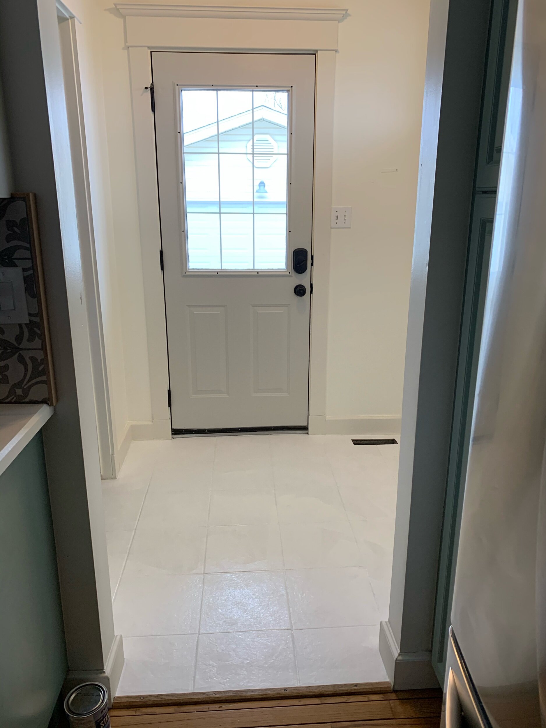 this is a photo of a back entryway with bonding primer on tile floors