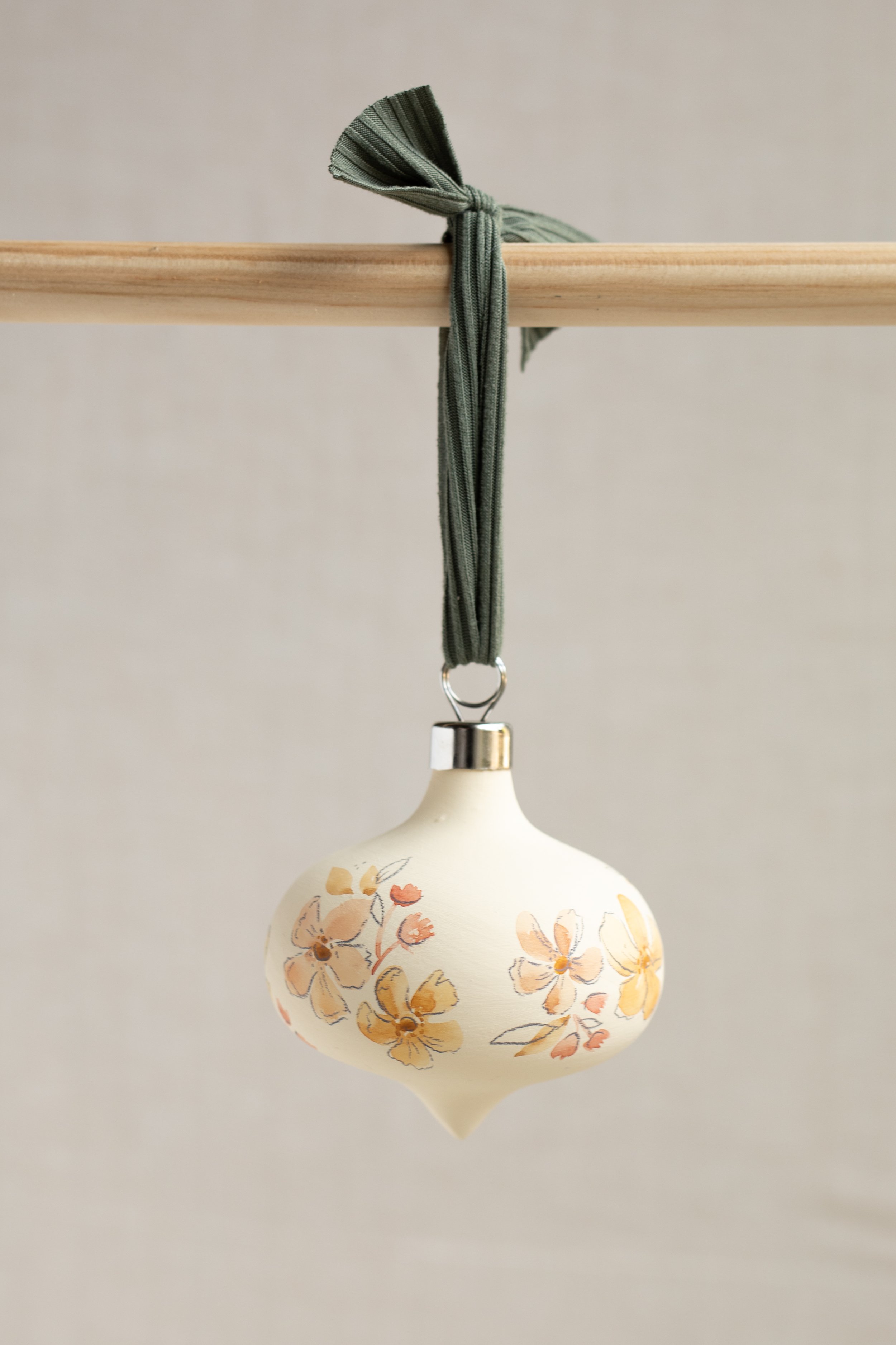 Handmade watercolor bisque ornament. Small business, shop small. Memphis, TN Ellywise Studios artist, 2022 cottagecore Christmas. Warm cream, golden florals, sweater tying fabric