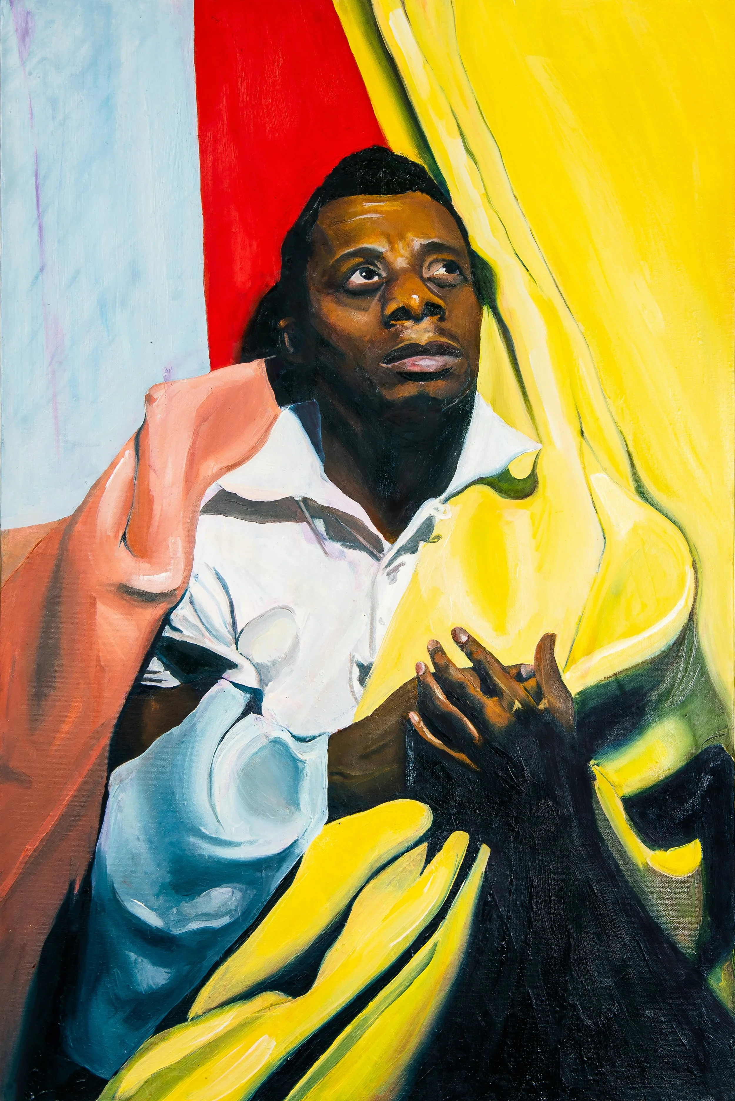 James Baldwin stands in a white collar shirt, hands over his heart and thick drapery cascading from above to fall over his chest and shoulders.