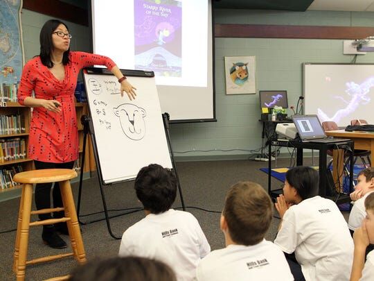 Grace presenting in front of a class.