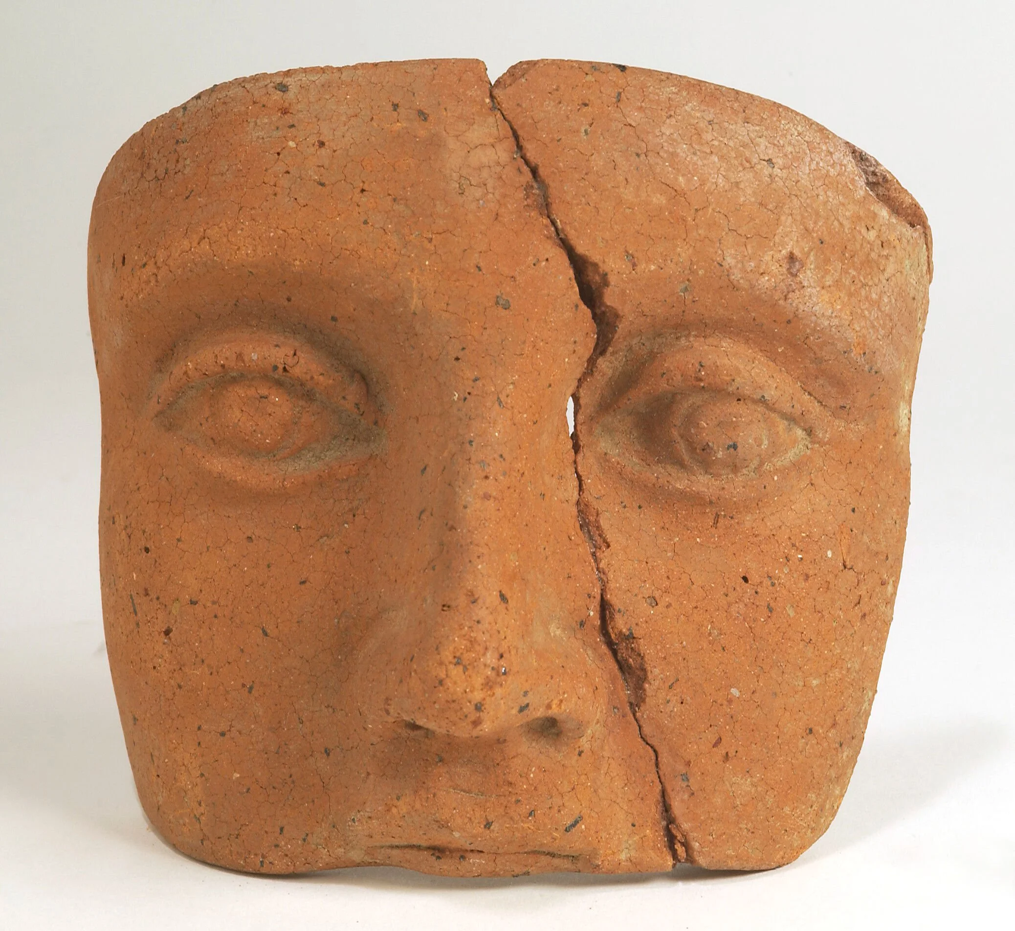 A clay-backed face. Roman votive offering. Wellcome Collection..jpg