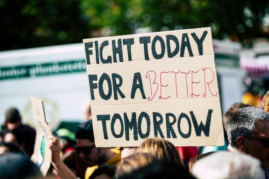 3.	A group of people holding a sign: "Fight Today for a Better Tomorrow".