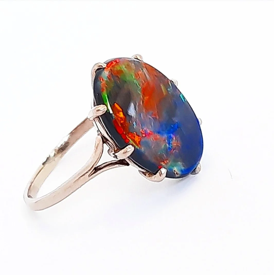 ART DECO BLACK OPAL AND GOLD RING
Featuring a Lightning Ridge black oval opal with fine play of colour, weighing an estimated 4.0cts, claw set in 18kt white gold, ring size 7. Australian 1930's.