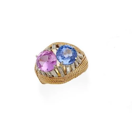 STERLE MID CENTURY 1960's SAPPHIRE DIAMOND GOLD AND PLATINUM RING A pair of round pink 2.52 cts and blue 2.20 cts sapphires set in a platinum basket also set with baguette cut diamonds to the twisted cord 18ky gold ring. Signed Sterle, French and mak