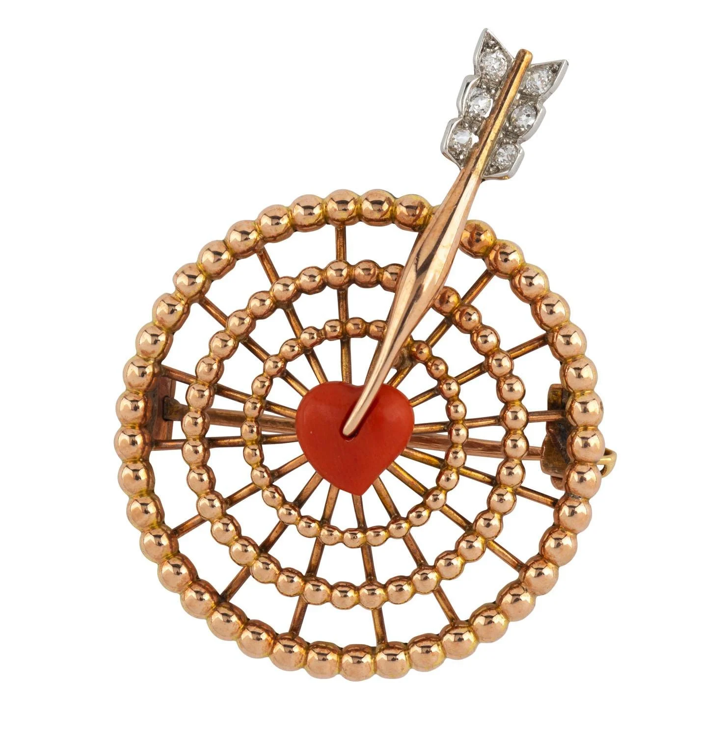 A decorative pin with a circular design made of gold or rose gold beads, featuring a red heart at the center and a gold arrow with diamond accents passing through it.