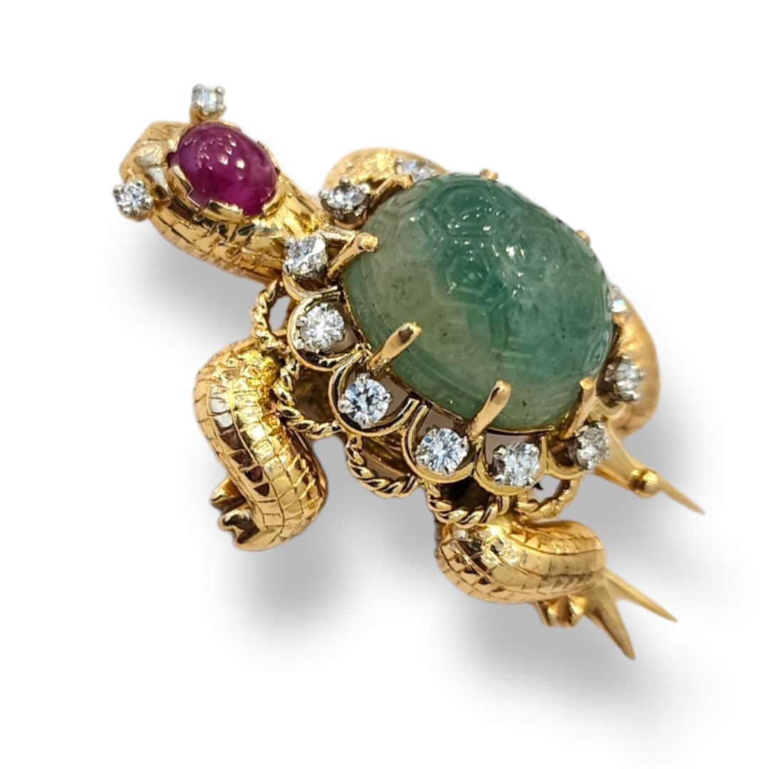 1960'S GEMSET TURTLE BROOCH. The turtle set with a carved emerald, diamonds, and ruby accents. French marks