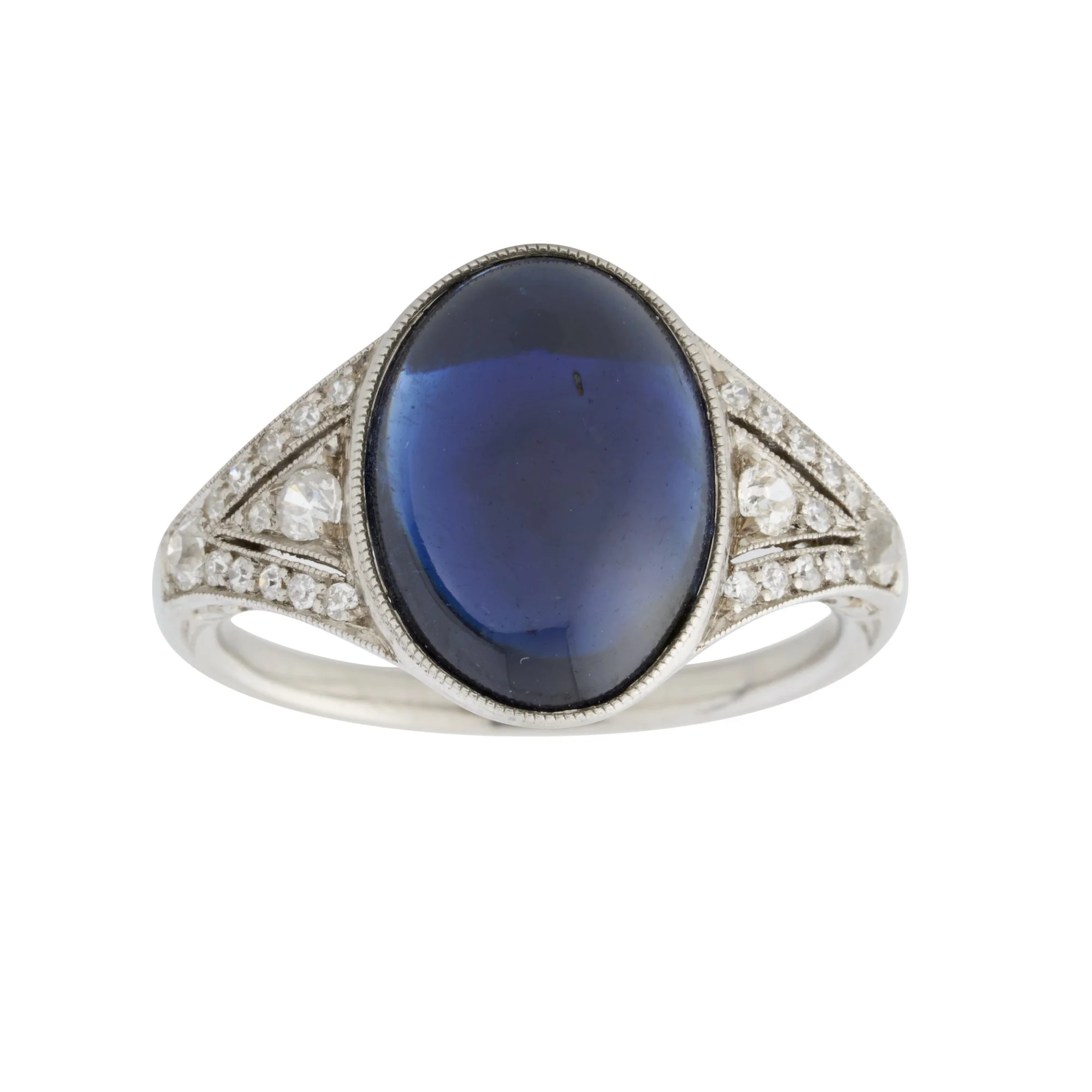 ART DECO 1920'S SAPPHIRE AND DIAMOND PLATINUM RING
 Centering upon a cabochon sapphire of circa 6 cts (13.37x9.81x4.58 mm) bezel set to the platinum ring set with old cut and single cut diamonds.