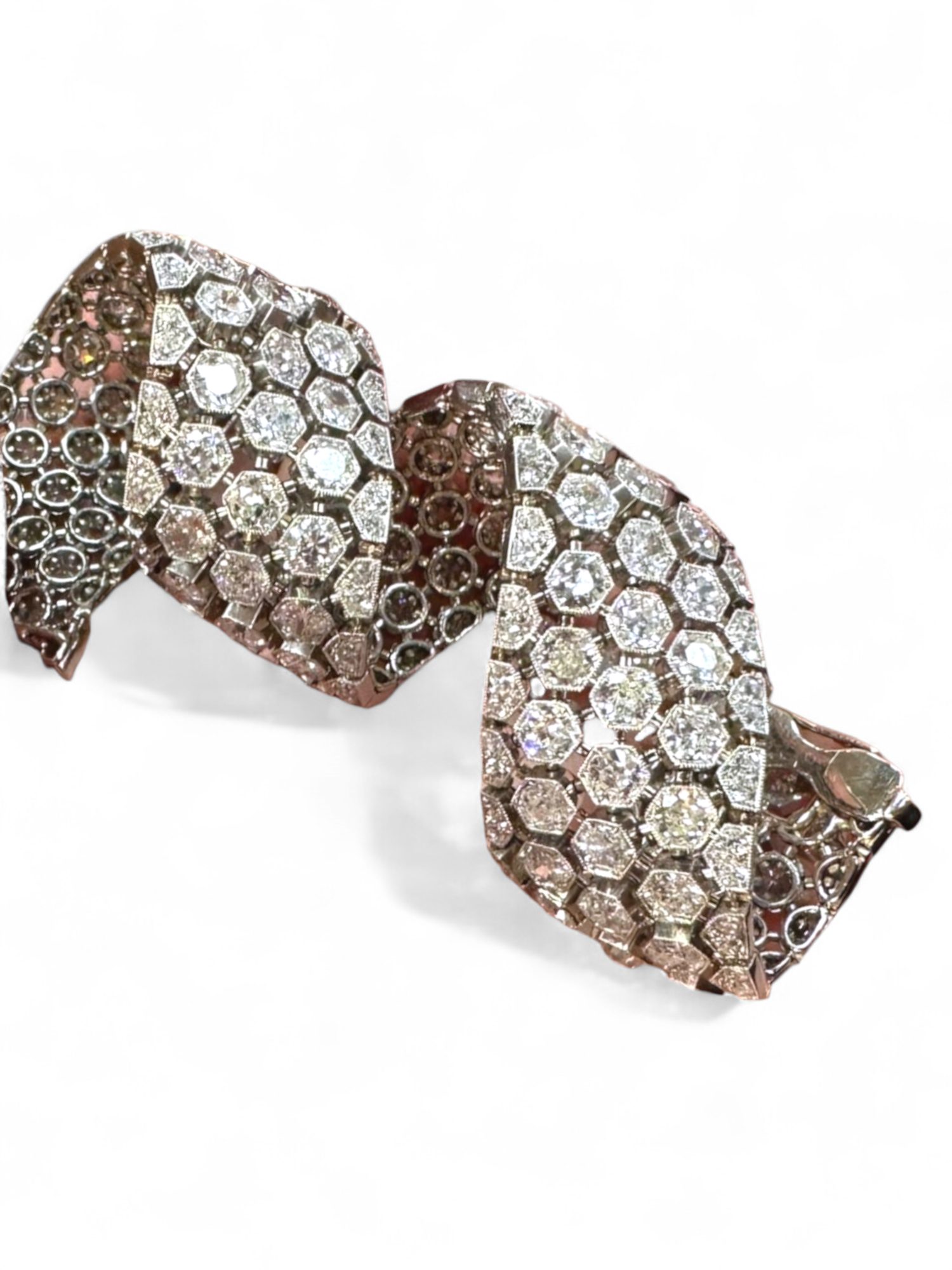 MID CENTURY PLATINUM AND DIAMOND BRACELET.
 Highly articulated platinum bracelet set with approximately 13 cts of round diamonds in hexagonal boxes forming a honeycomb pattern. 15.5 cm length. French marks