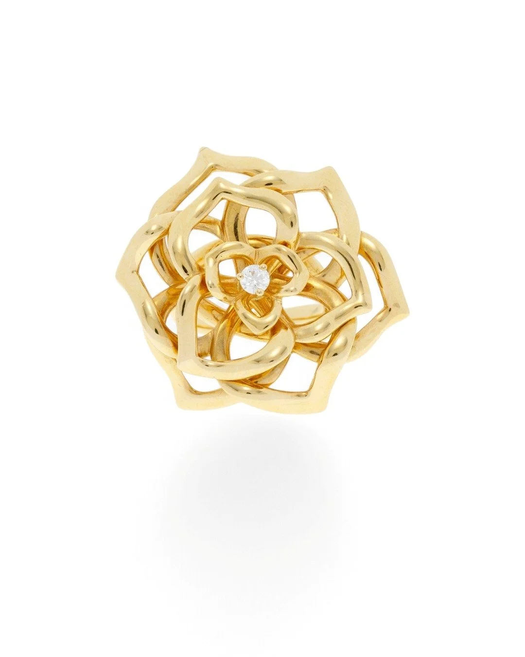 PIAGET GOLD AND DIAMOND FLOWER RING. 18kt gold ring stylizing a rose with openwork petals centering a brilliant-cut diamond, signed, numbered