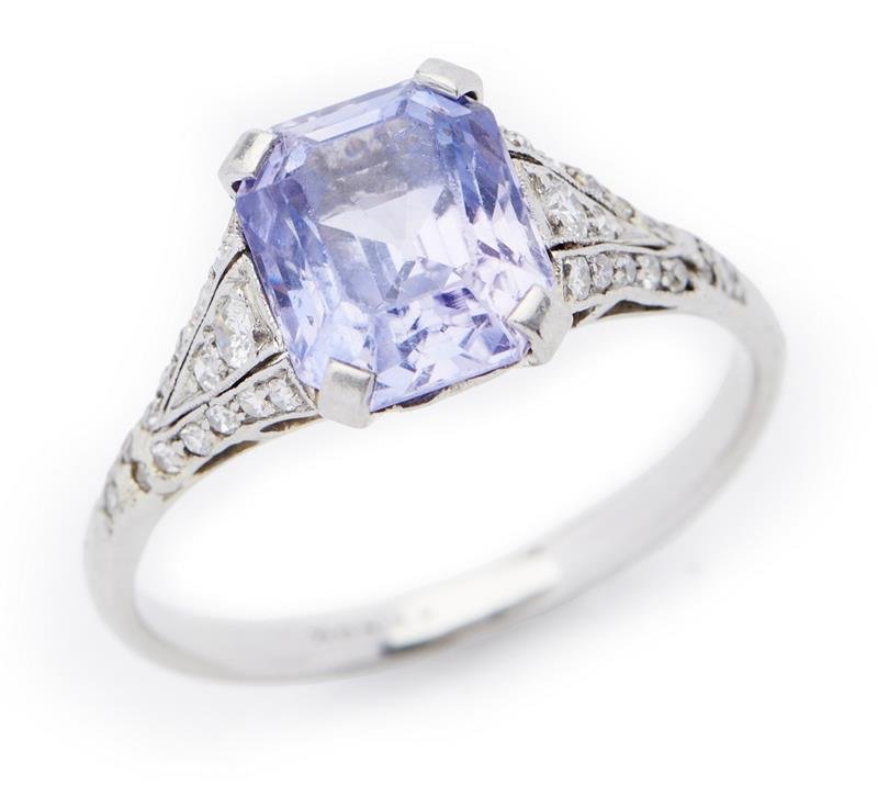 BELLE EPOQUE 1910'S Platinum Sapphire and diamond ring  featuring a lavander emerald cut Ceylon sapphire weighing 3.20cts, to decorative diamond set shoulders, in platinum, ring size N 1/2. With GSL Gemstone Authentication Report  number AA64011 date