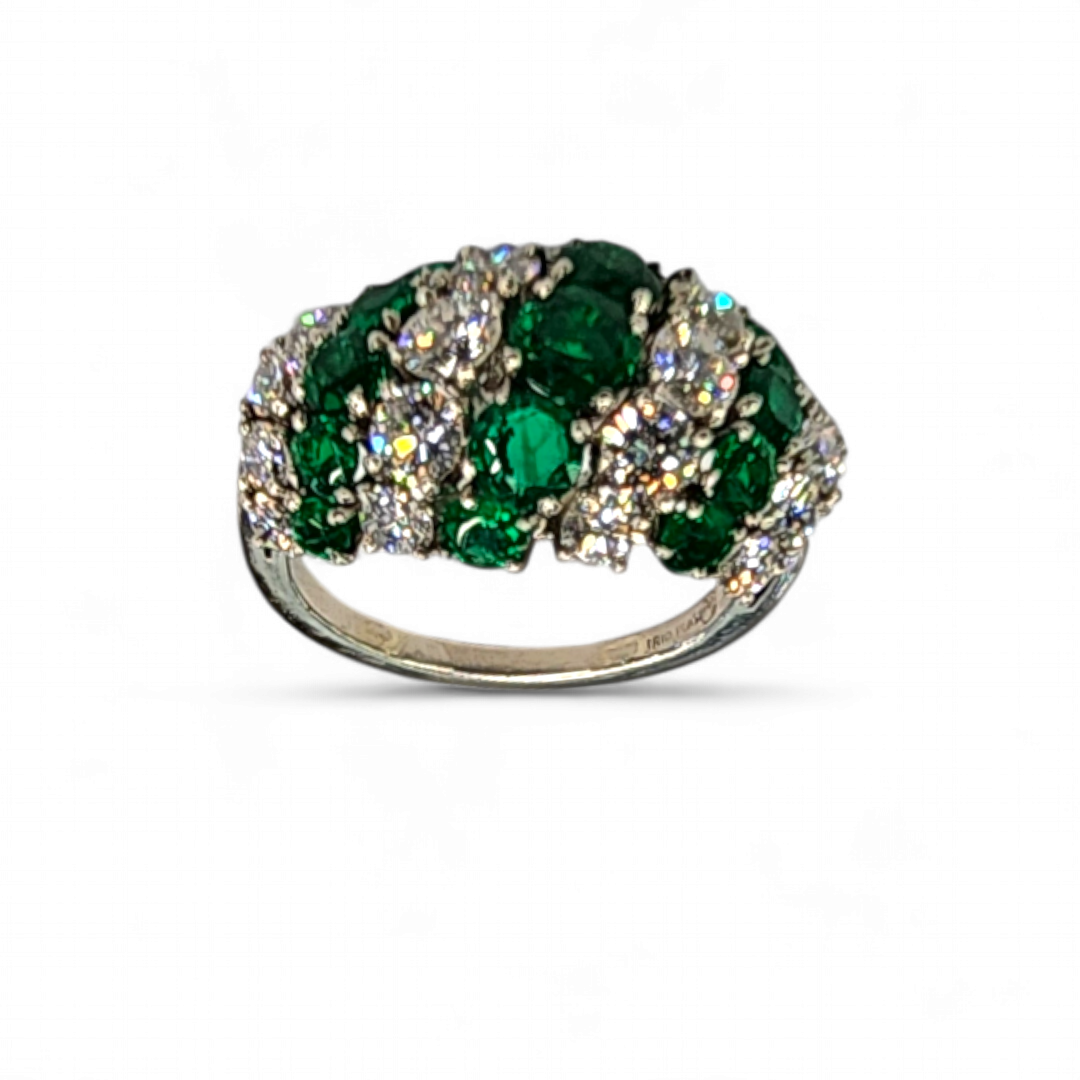 MCTEIGUE & CO 1950'S EMERALD AND DIAMOND DRESS RING.Of dome design alternating bands of prong set round Colombian emeralds and diamonds.