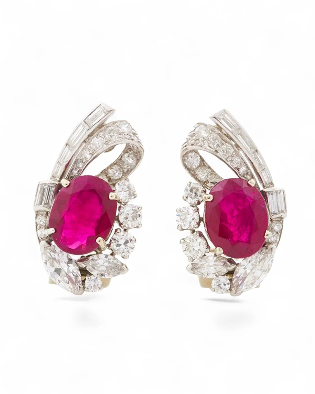 RAYMOND YARD, MID CENTURY BURMA RUBY AND DIAMOND PLATINUM EARRINGS.  Of swirl design, set with a pair of oval-shaped rubies weighing 3.98 and 3.83 carats, finely set with baguette, old European, old mine-cut and marquise-shaped diamonds weighing appr