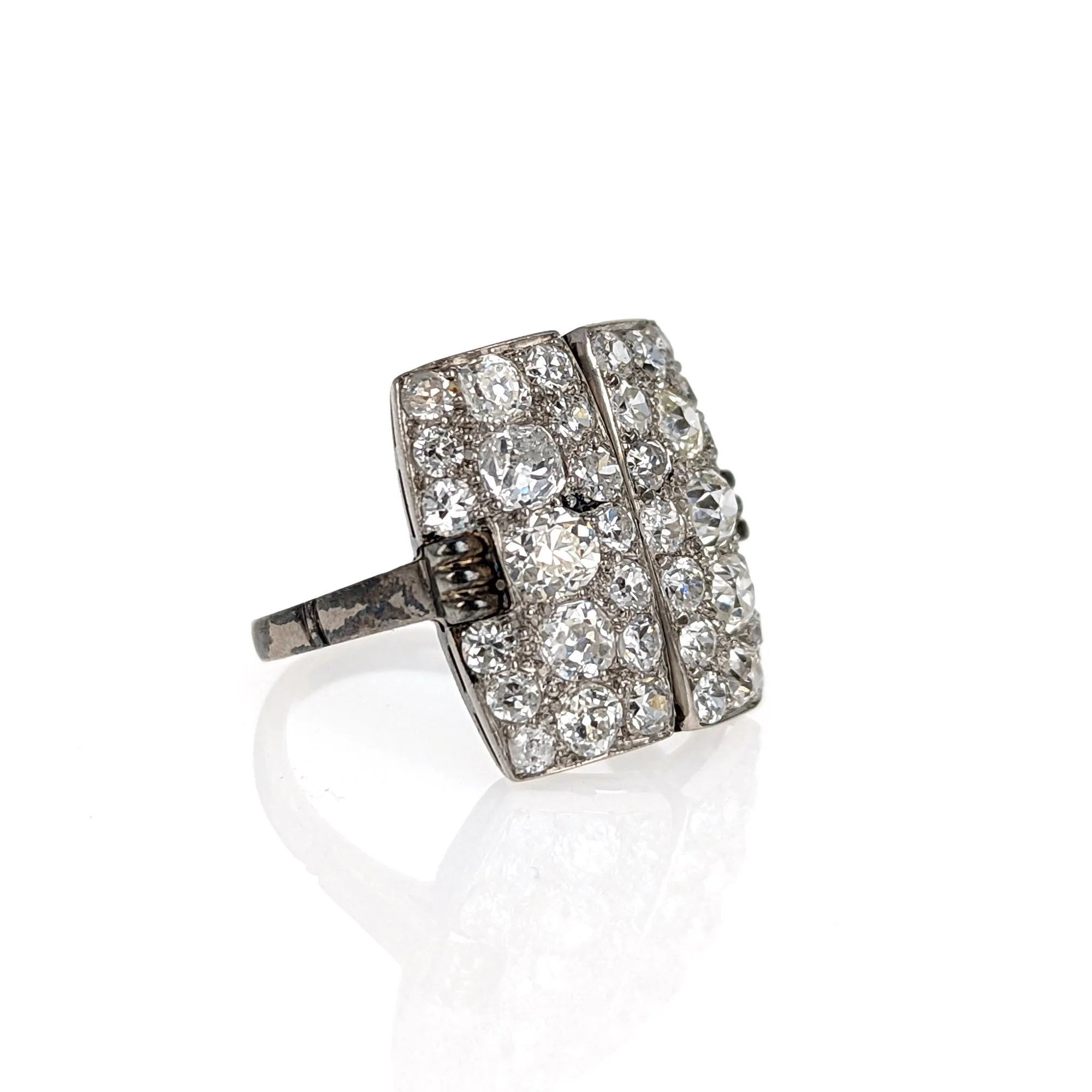 ART DECO DIAMOND AND PLATINUM RING
designed as two panels set with old-mine and round cut diamonds
weighing approximately 3 carats, mounted in platinum, circa 1930,