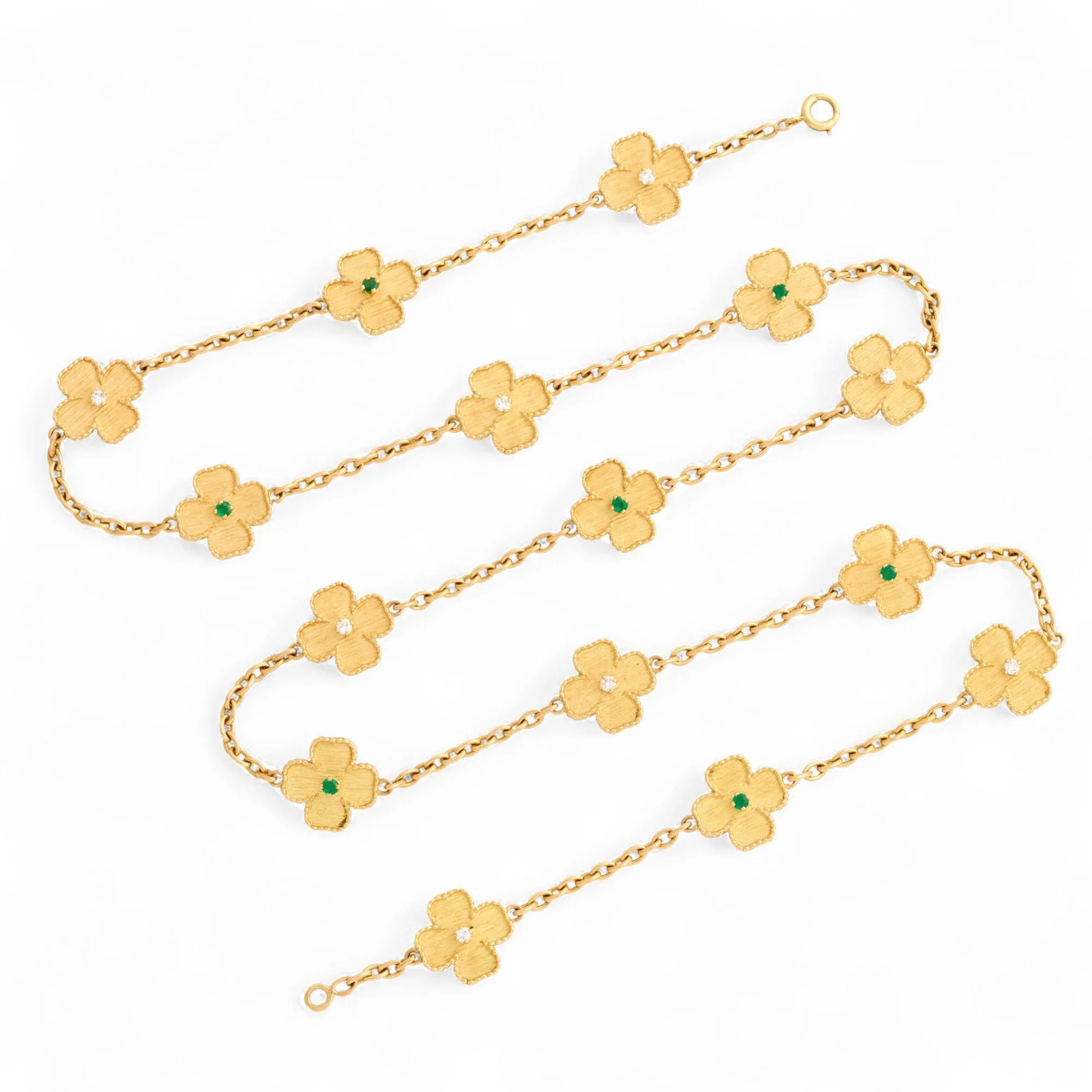 1970'S GOLD, DIAMOND AND EMERALD LONG CHAIN In 18k yellow gold, the long chain dotted with a multitude of four-leaf clovers with a satin finish, enhanced with an alternation of brilliant-cut diamonds and round emeralds. Double sided.  French marks, L