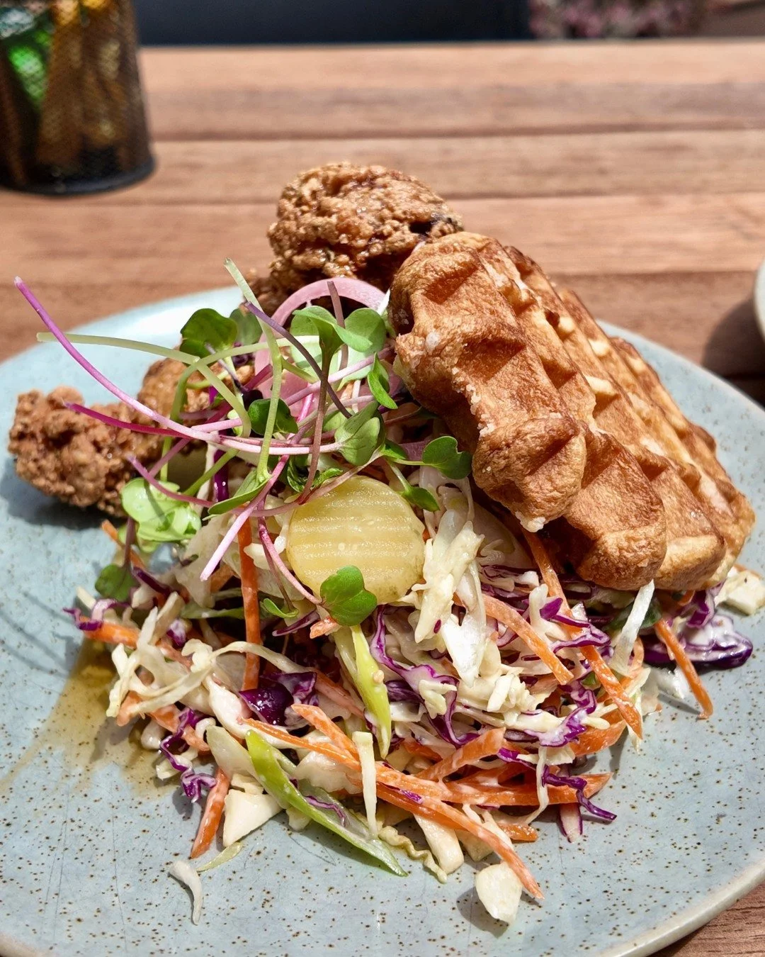 Belgian chicken waffles, but make it lunch 🍗🧇

Crispy chicken, golden waffle, crunchy slaw, and pickles for that perfect bite 😍

Sweet, salty, and a little tangy, all on one plate.

Grab a seat outside and let us sort the rest ☀️

Would you add ex