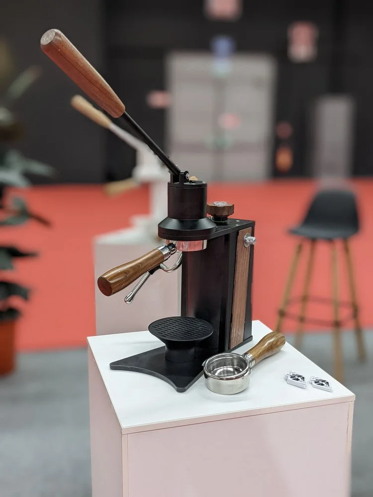   Original mockup of the black color with Walnut accents and LHS steam wand at WOC Milan.  
