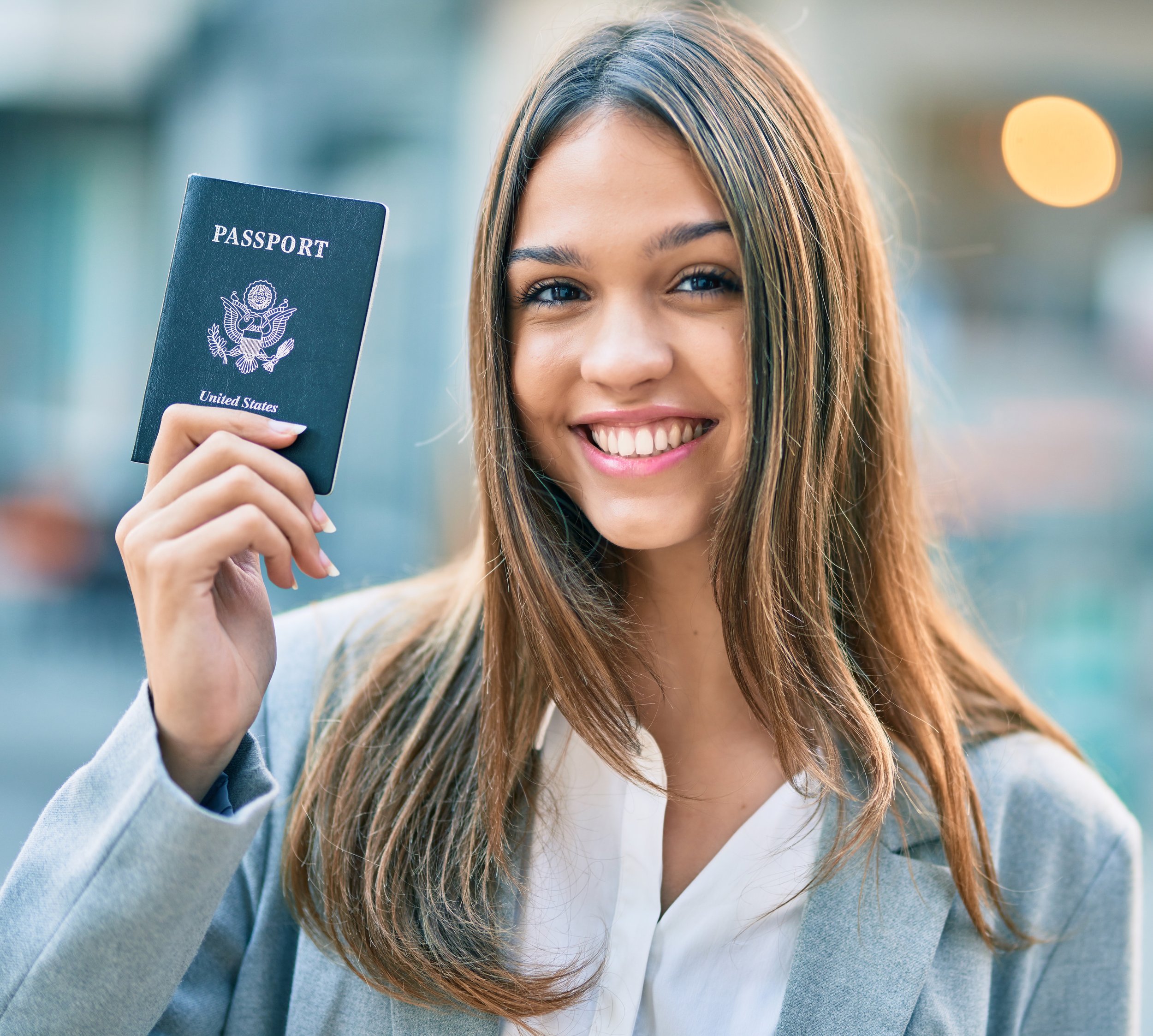 girl hold a passport with smile
