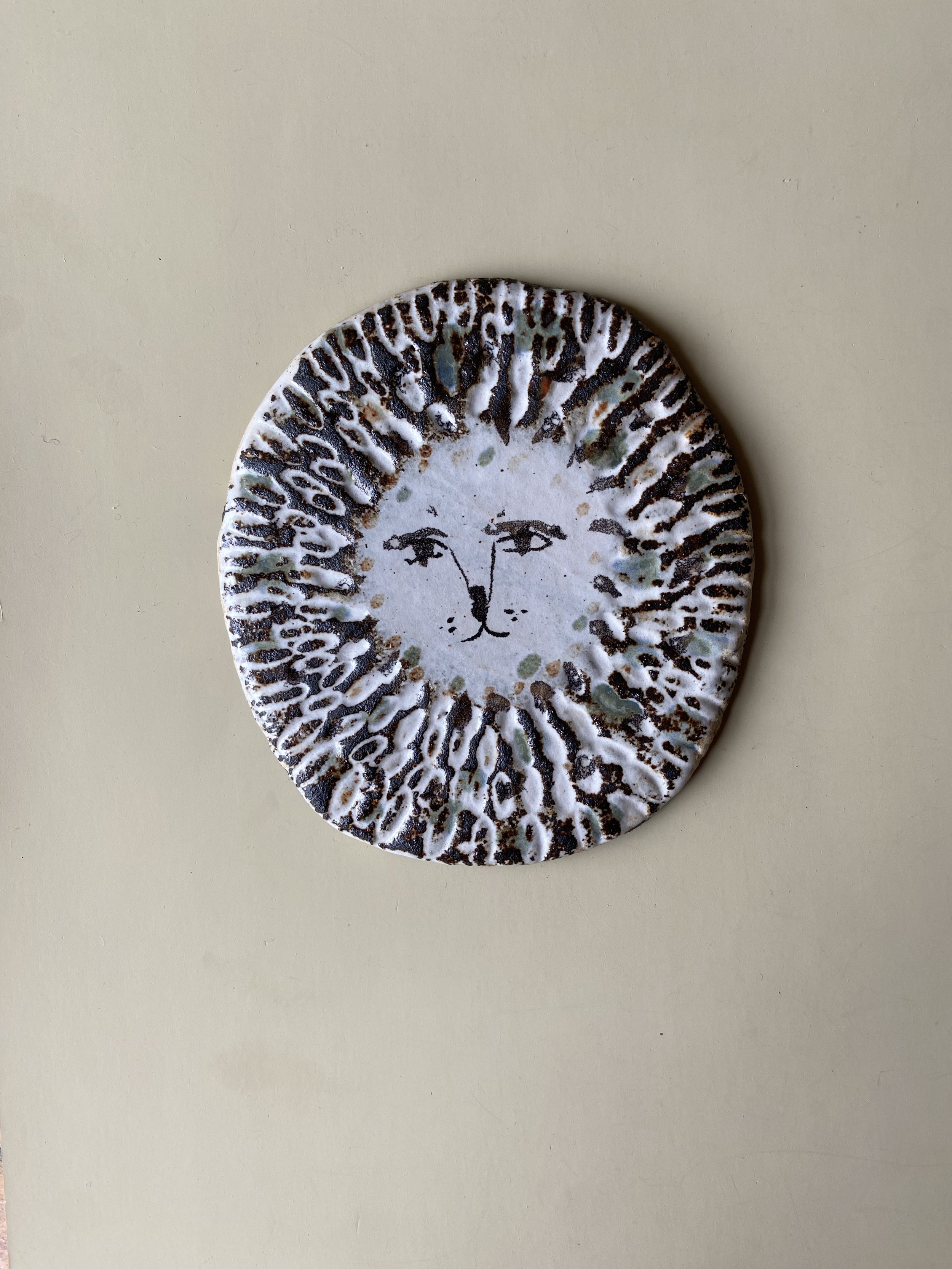 handmade ceramic lion face tile by Charlotte Salt