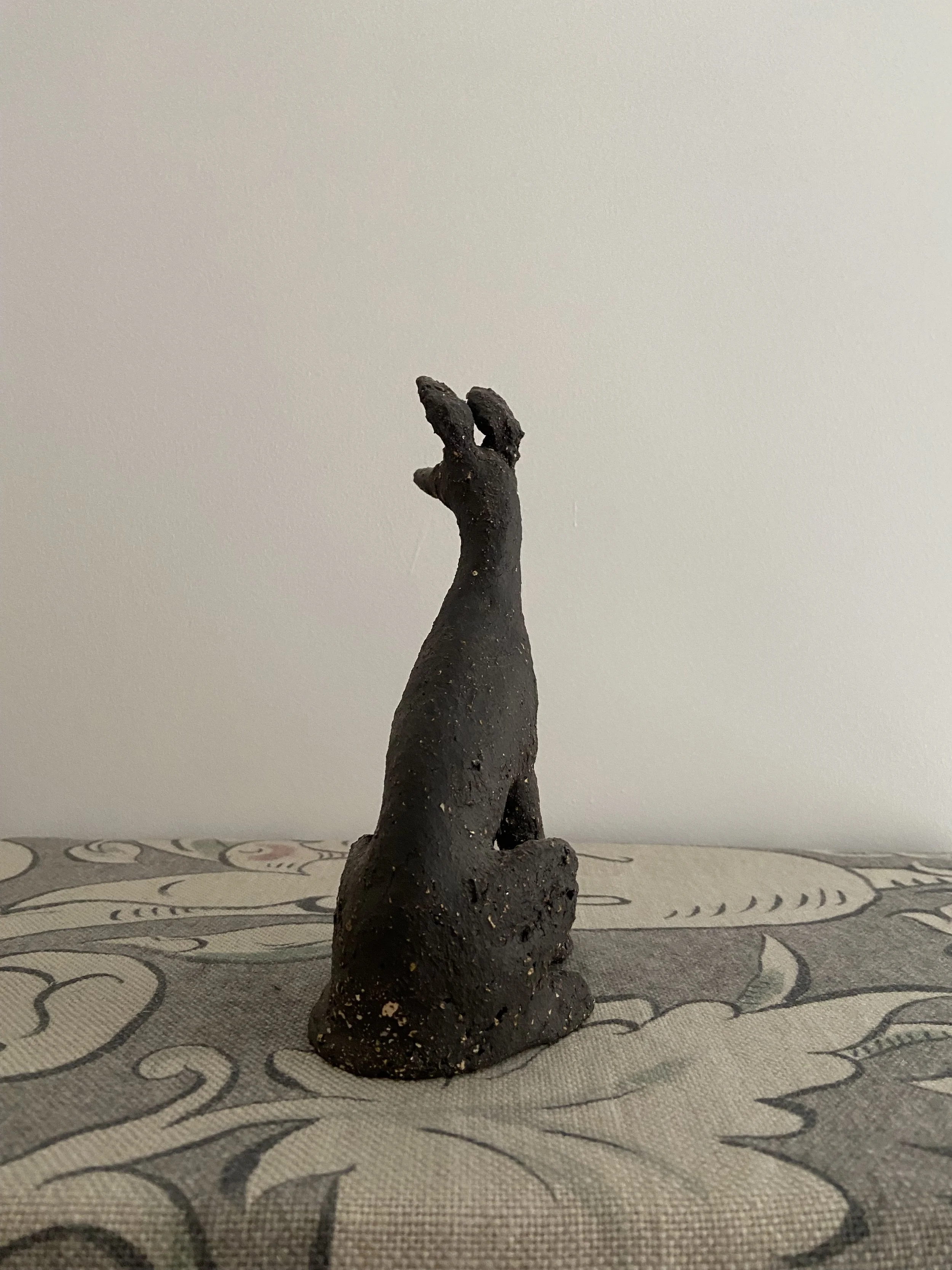 Stoneware seated hounds by Charlotte Salt