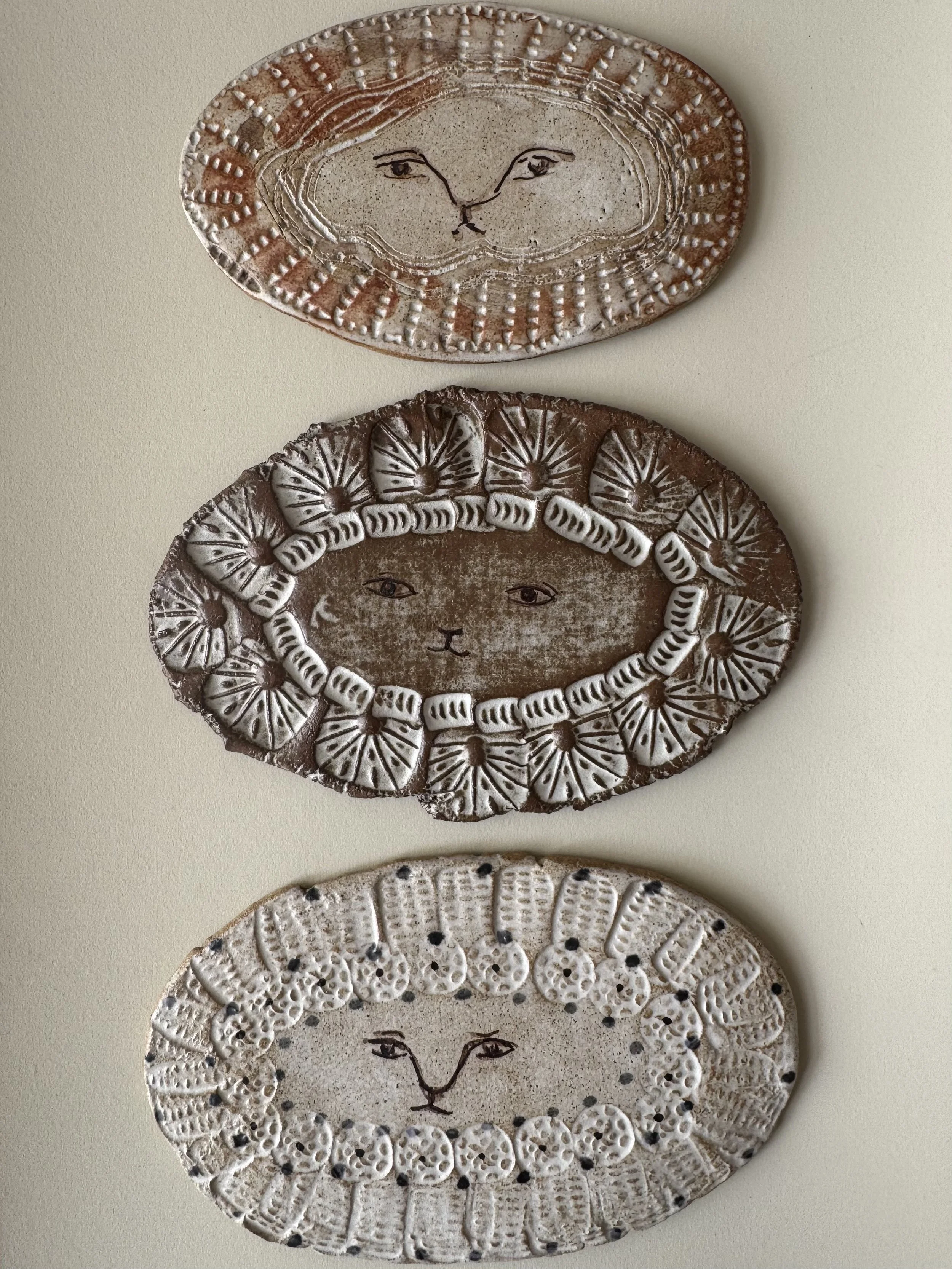 Handmade ceramic lion face tiles by Charlotte Salt