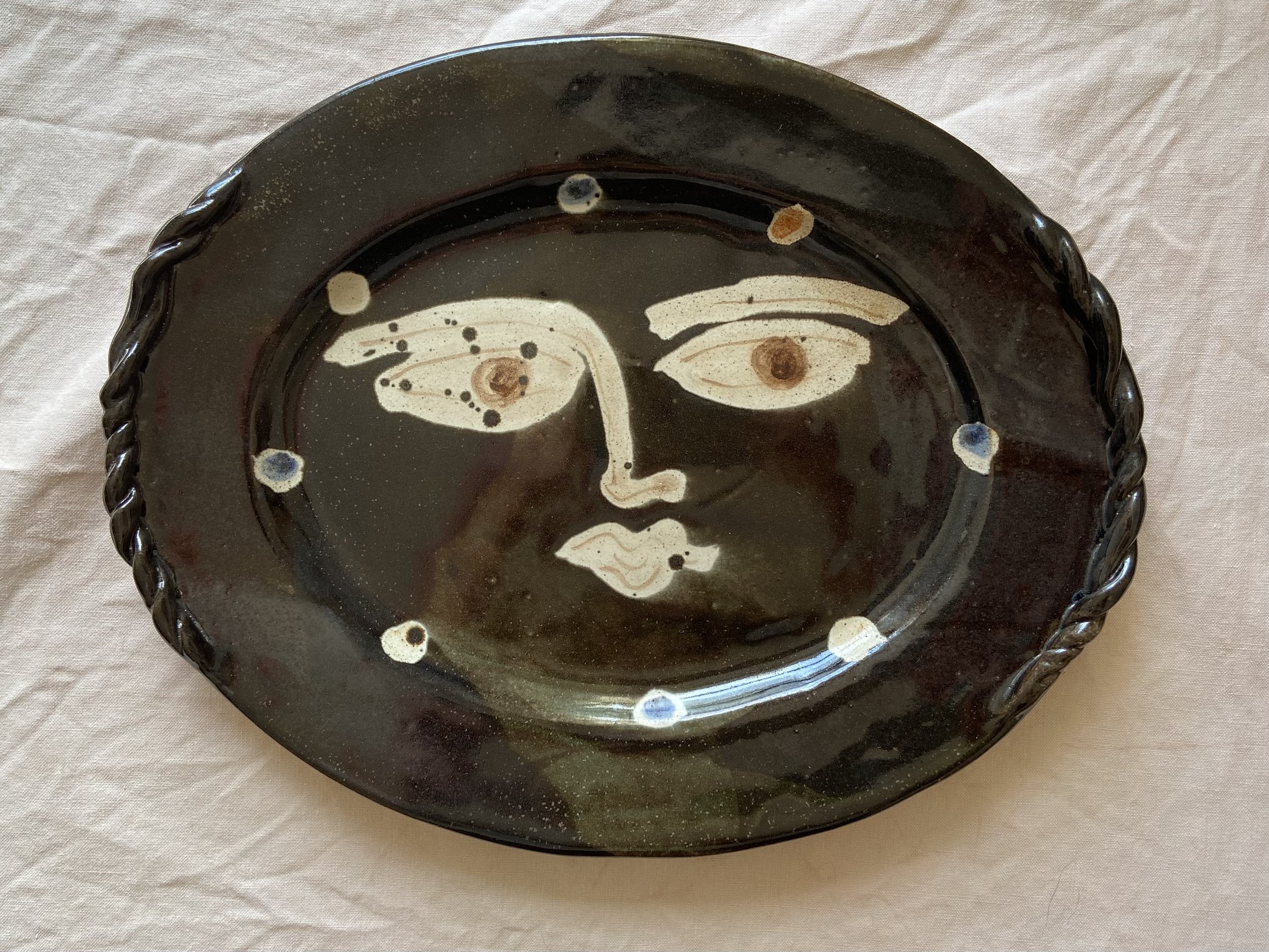 Oval face design Plate by Charlotte Salt