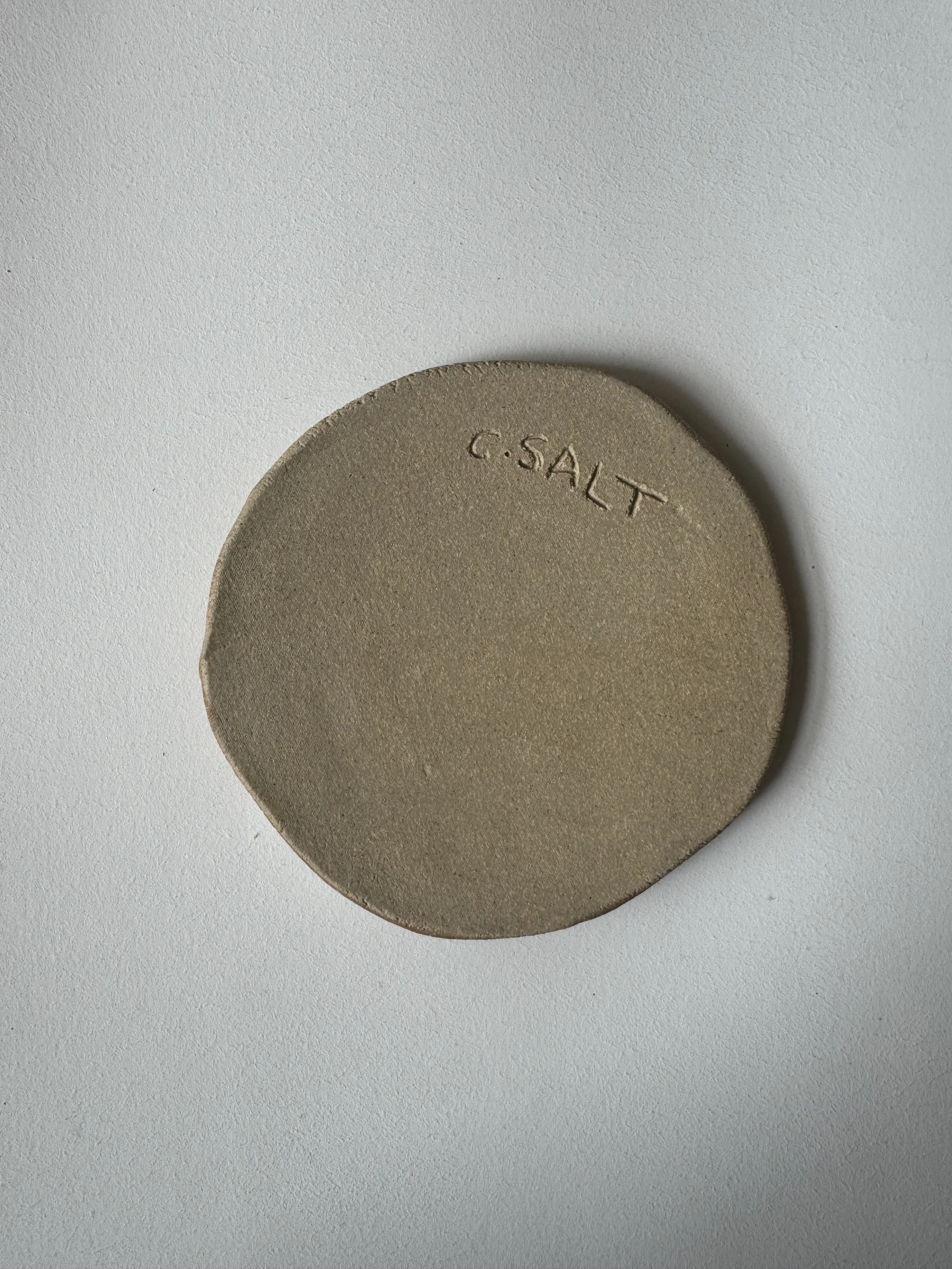 Ceramic face tile by Charlotte Salt