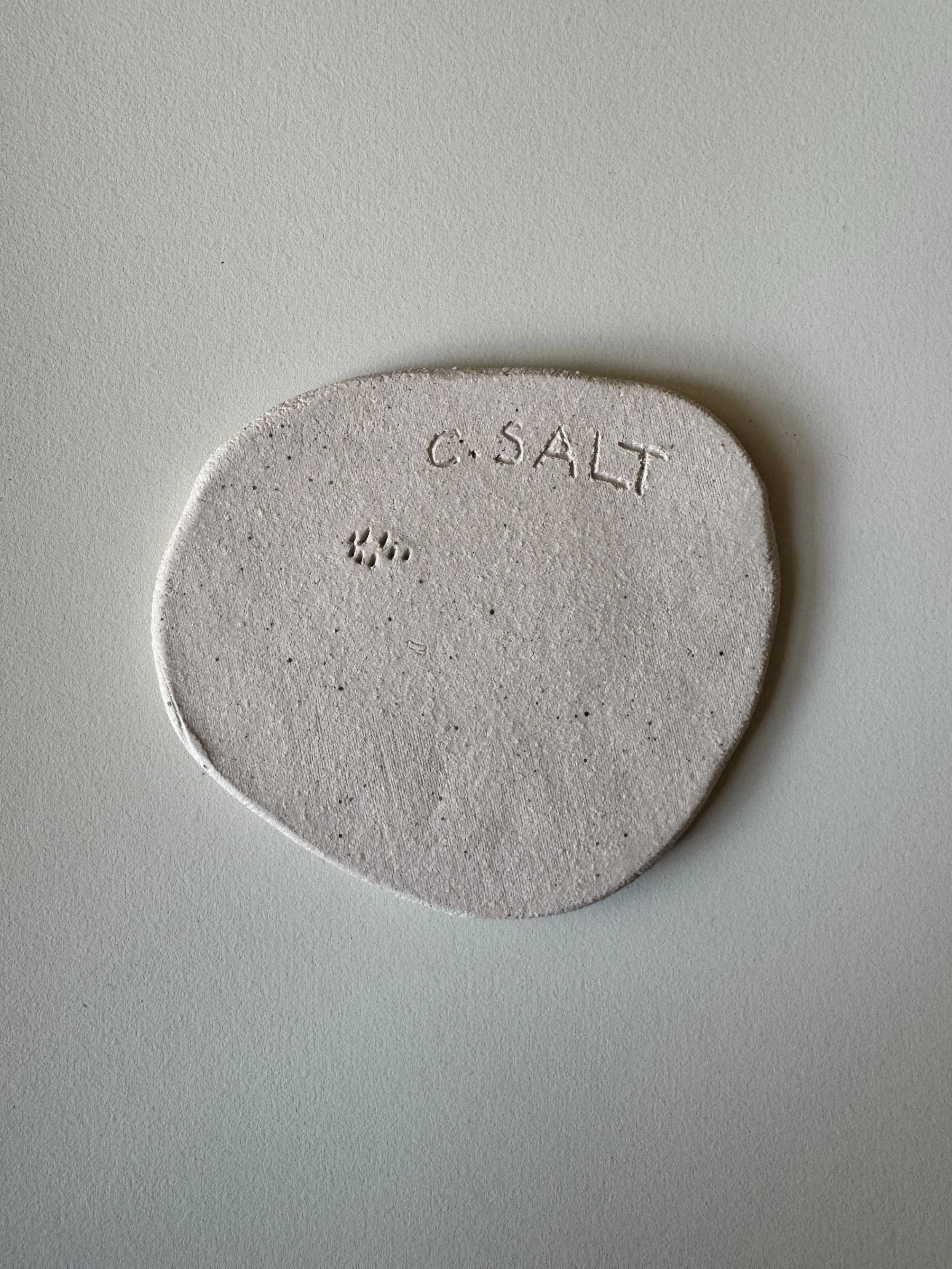 Ceramic face tile by Charlotte Salt