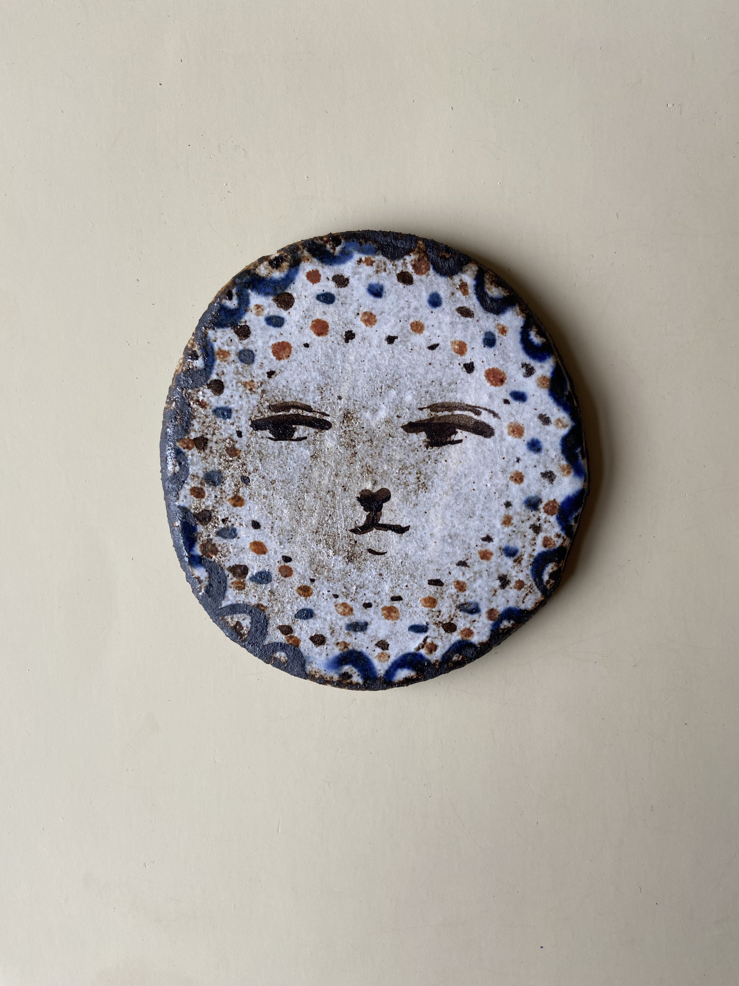 Handmade from black stoneware clay. Decorated with glaze and oxides. Dimensions: 8cm x 8cm