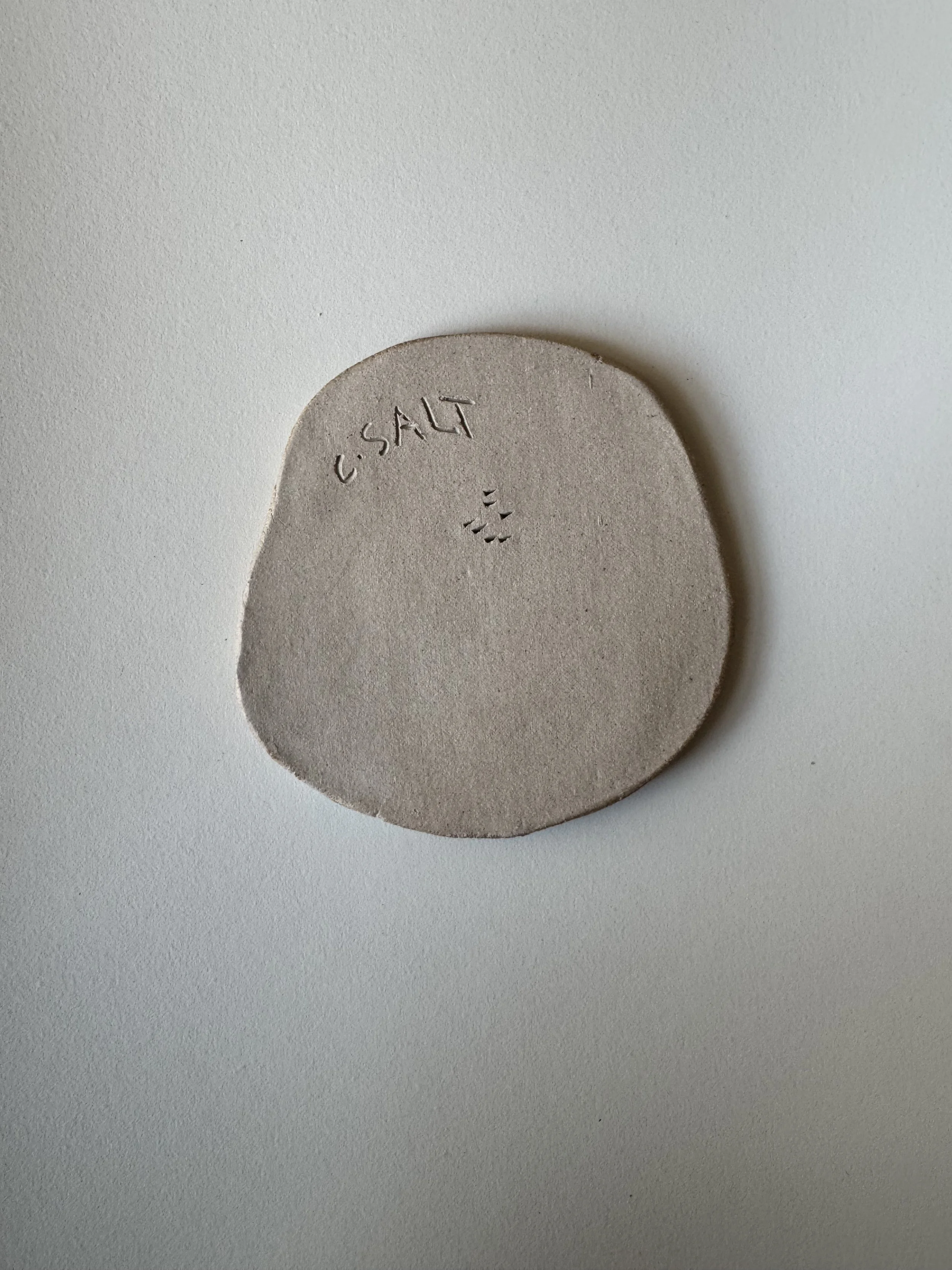 Ceramic face tile by Charlotte Salt