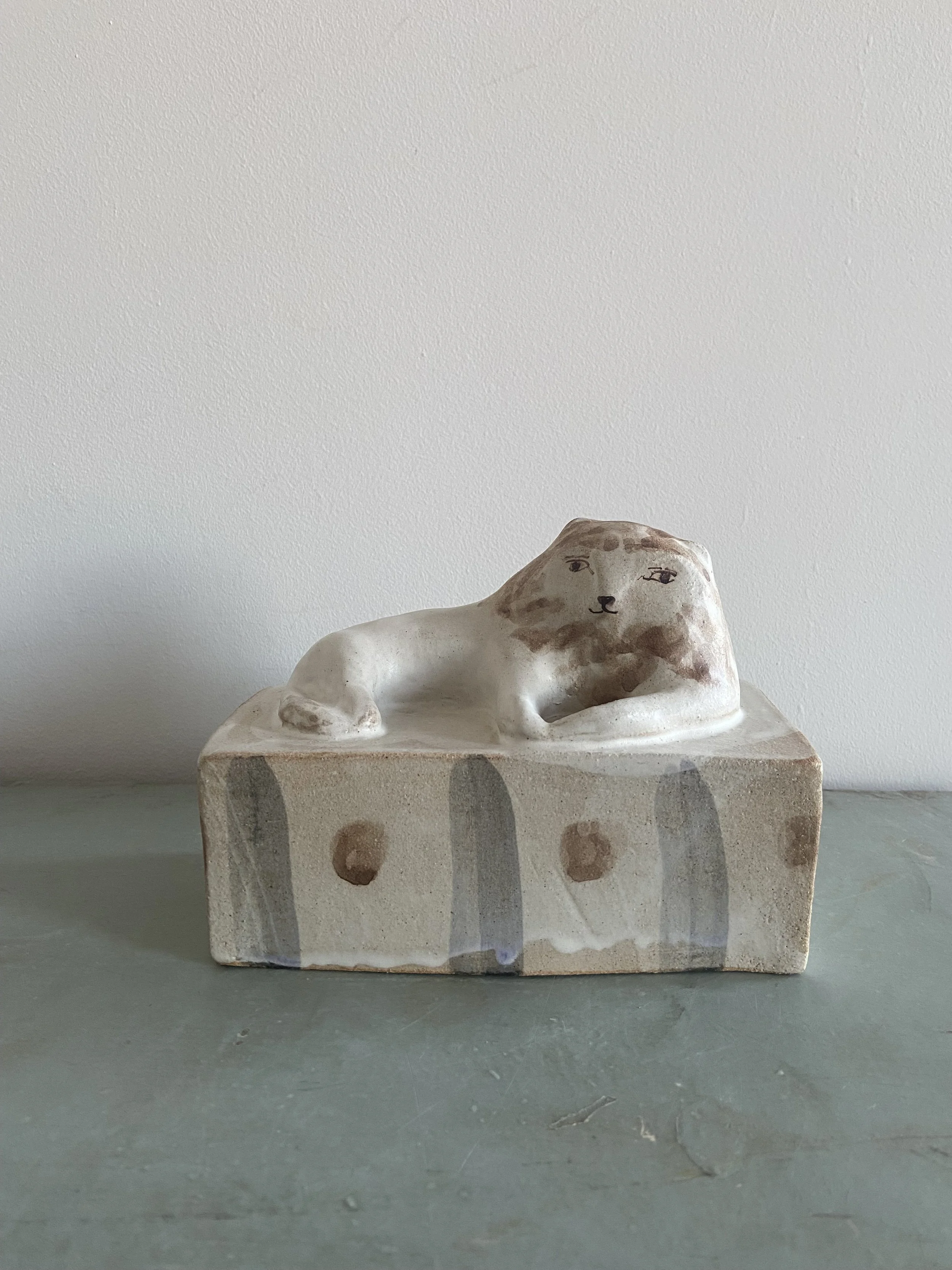 Lion on a Striped Base