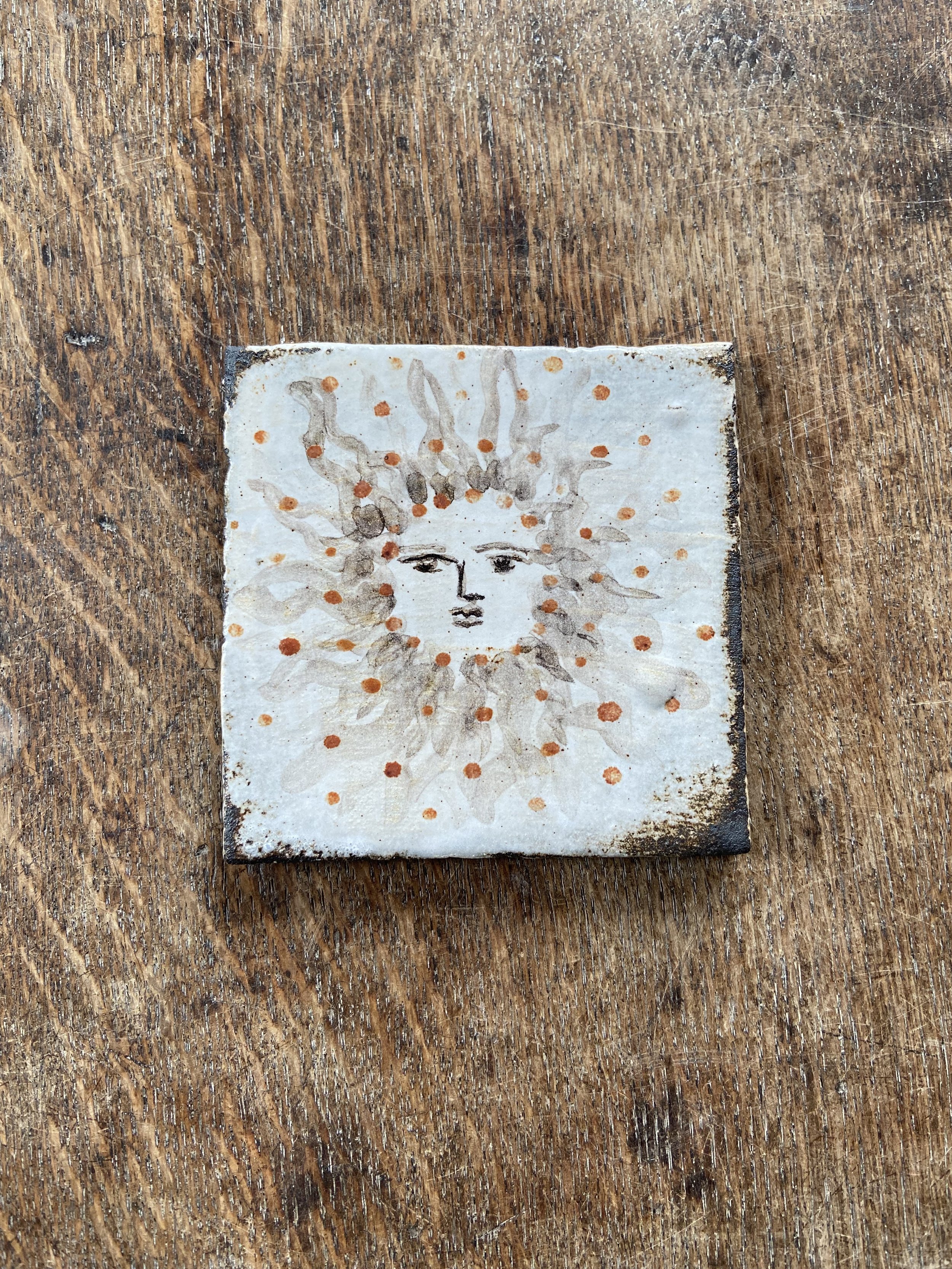 Handmade sun design tile by Charlotte Salt