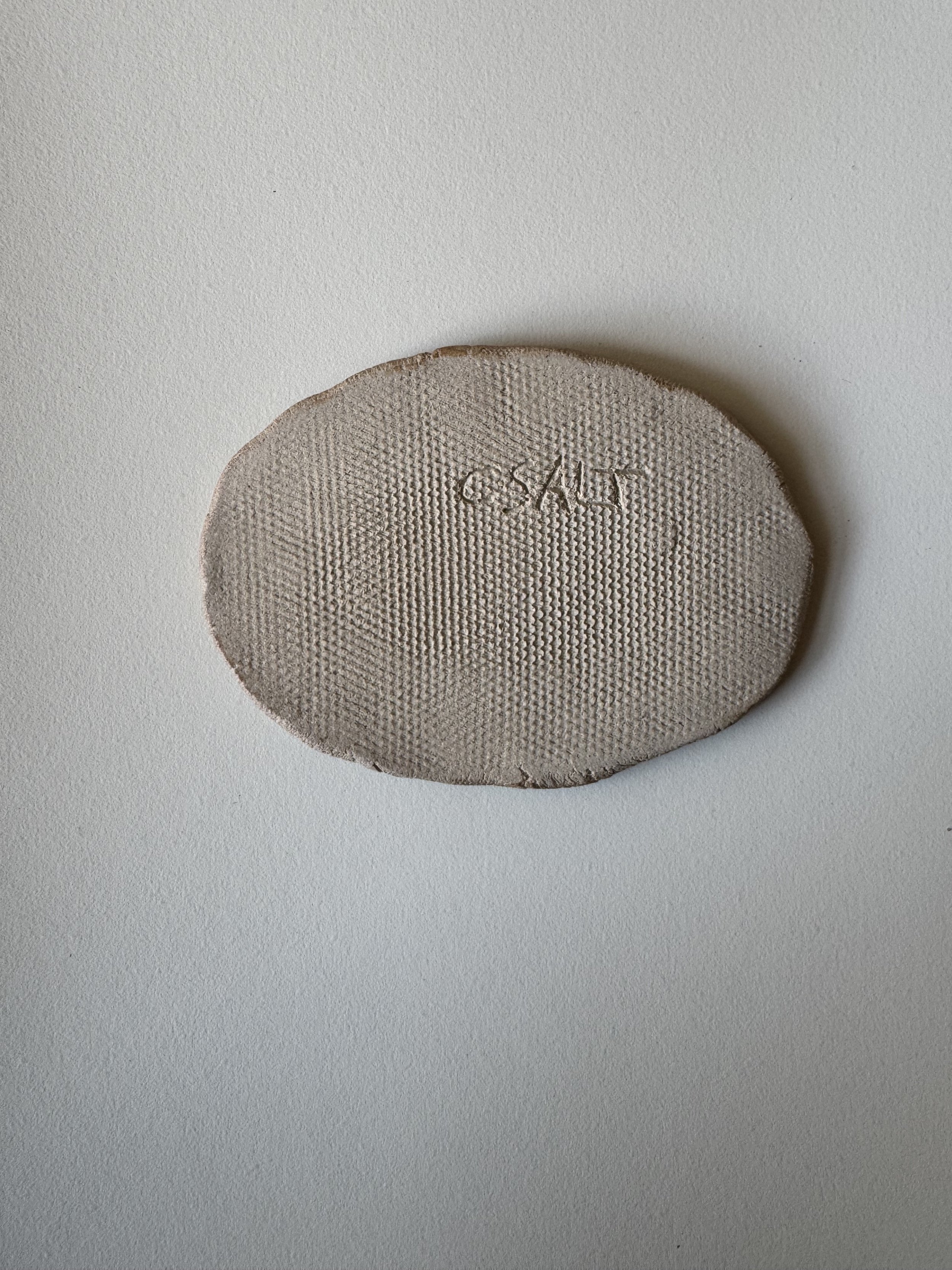 Ceramic face tile by Charlotte Salt