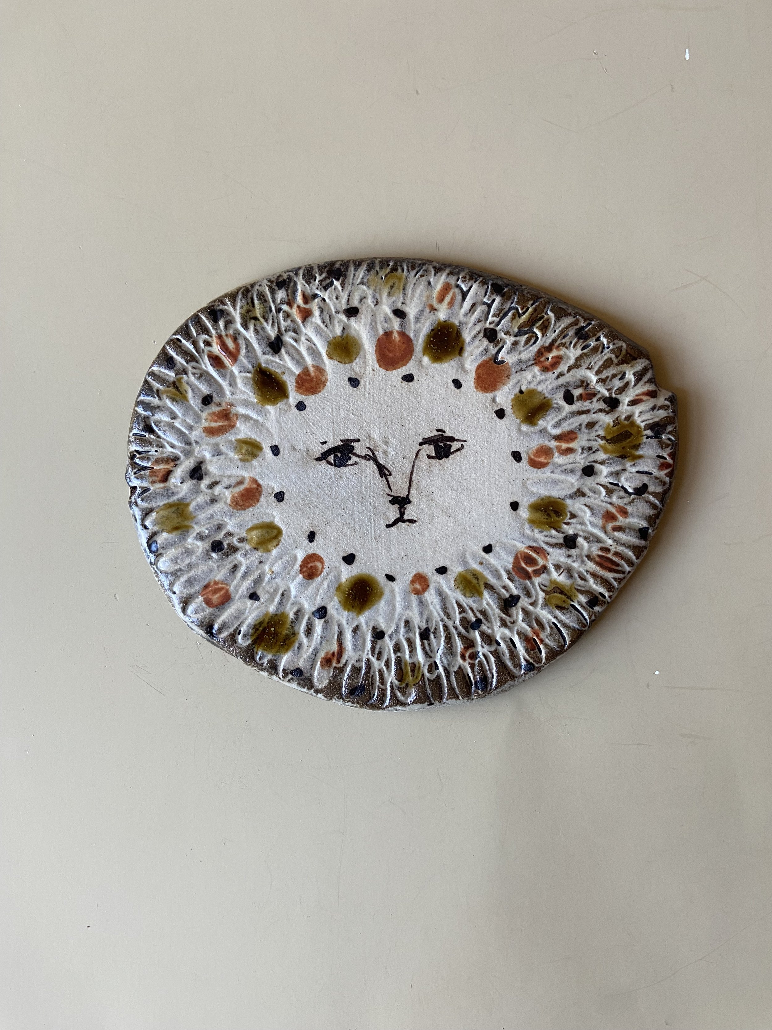 Handmade ceramic lion face tile by Charlotte Salt