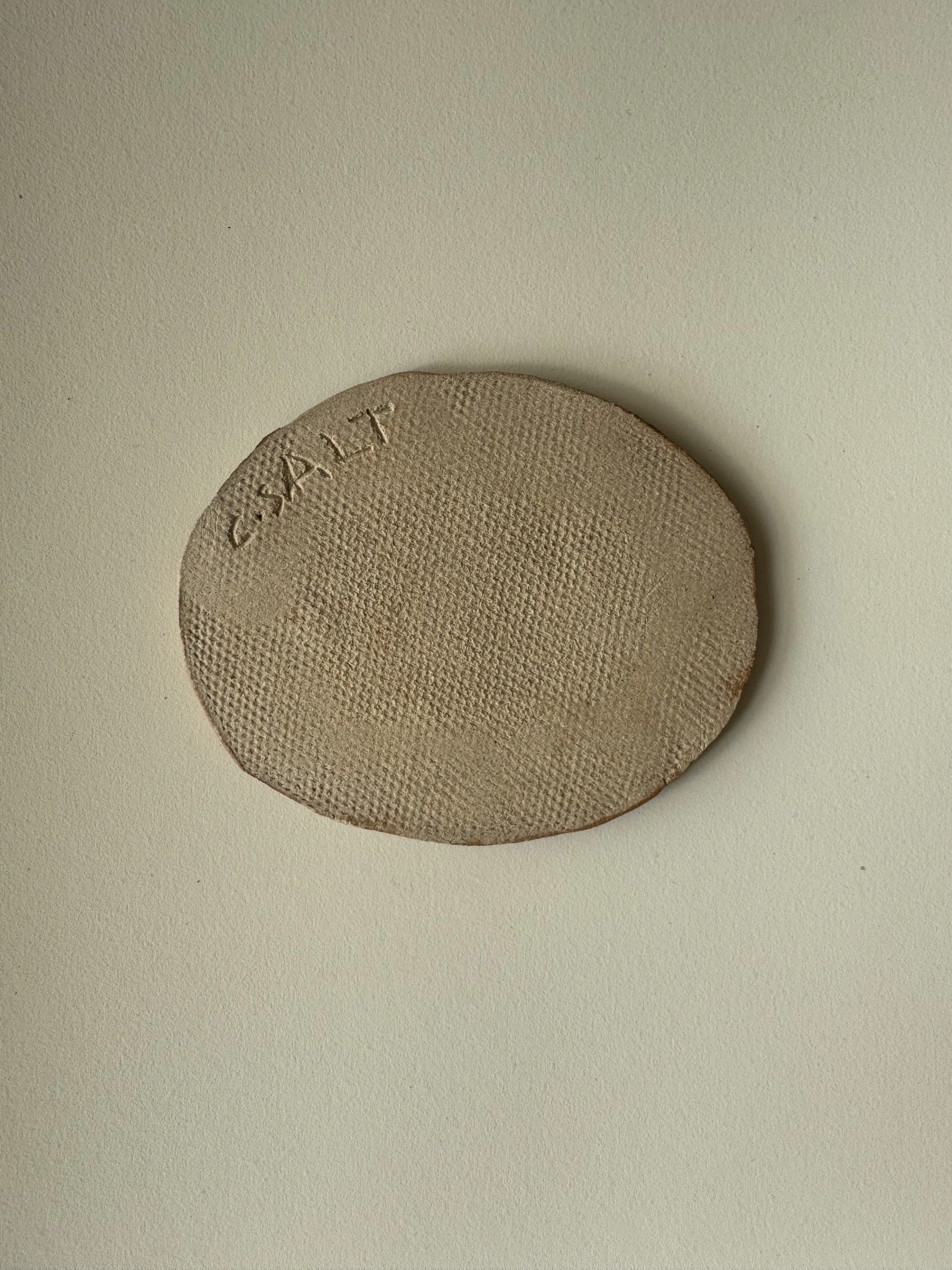 Ceramic face tile by Charlotte Salt